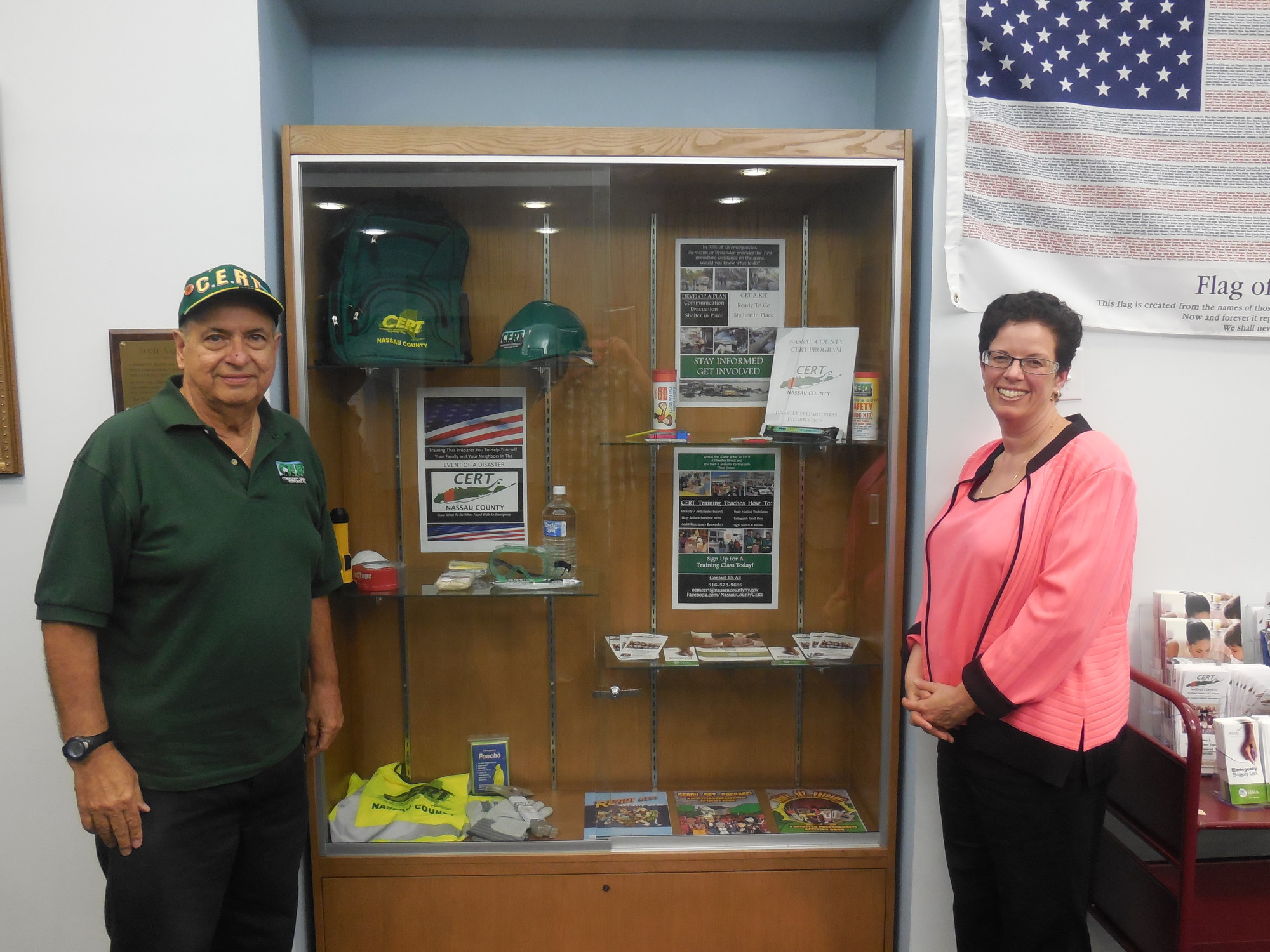 Island Park Public Library Trustee Joseph Pontecorvo and Library Director Jessica Koenig in front of the Nassau County CERT display. Mr. Pontecorvo has taken the necessary classes and has been certified by CERT.