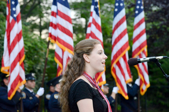 Jaquelin Kerschenbaum of Oceanside High School sang the national anthem at the 9/11 memorial at the Schoolhouse Green last Thursday.