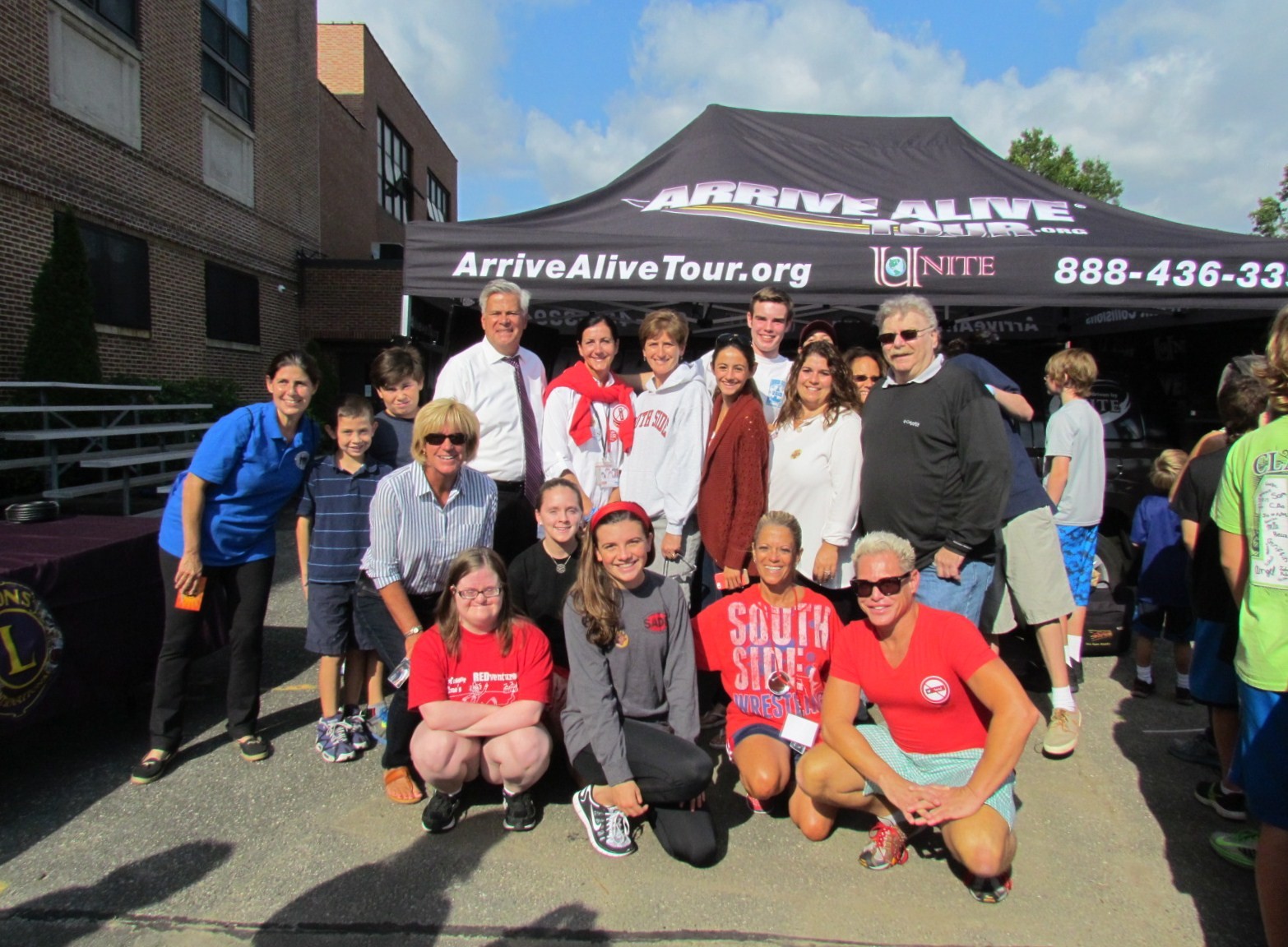 School officials and Youth Council members with Senator Dean Skelos outside the Arrive Alive tent, which teaches the consequences of drinking and driving.