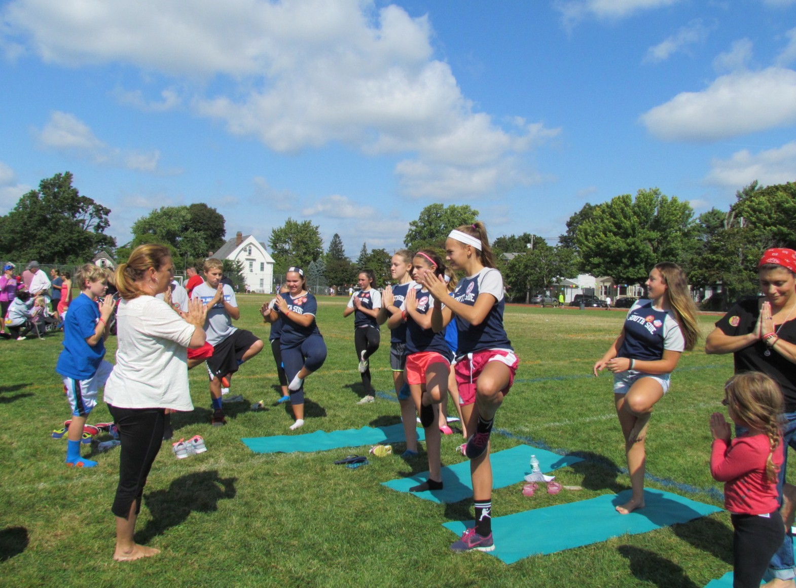 People practiced yoga on the field after the walk.