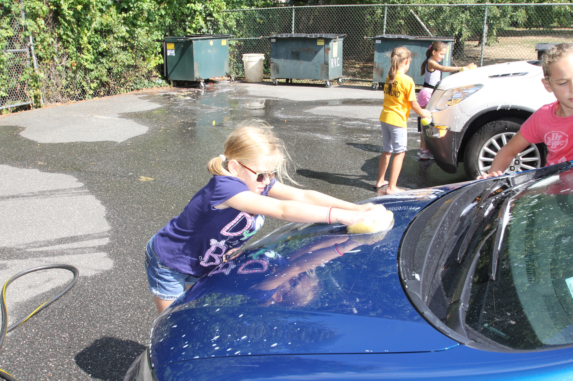 Gabriella sabatino cleaned tires and scrubbed down cars during the car wash.