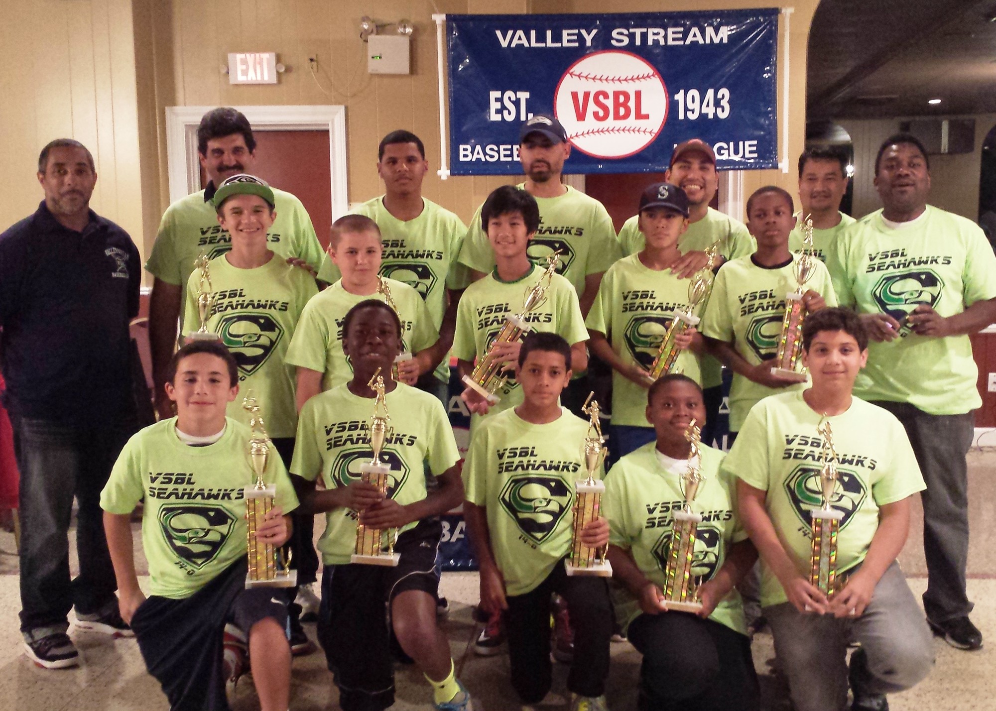 Valley Stream Baseball League President Bob Inzerillo, back row, second from left, dons a shirt celebrating the champions of the 12-and-under 'Derek Jeter' division, the Seahawks, coached by Nelson Martinez