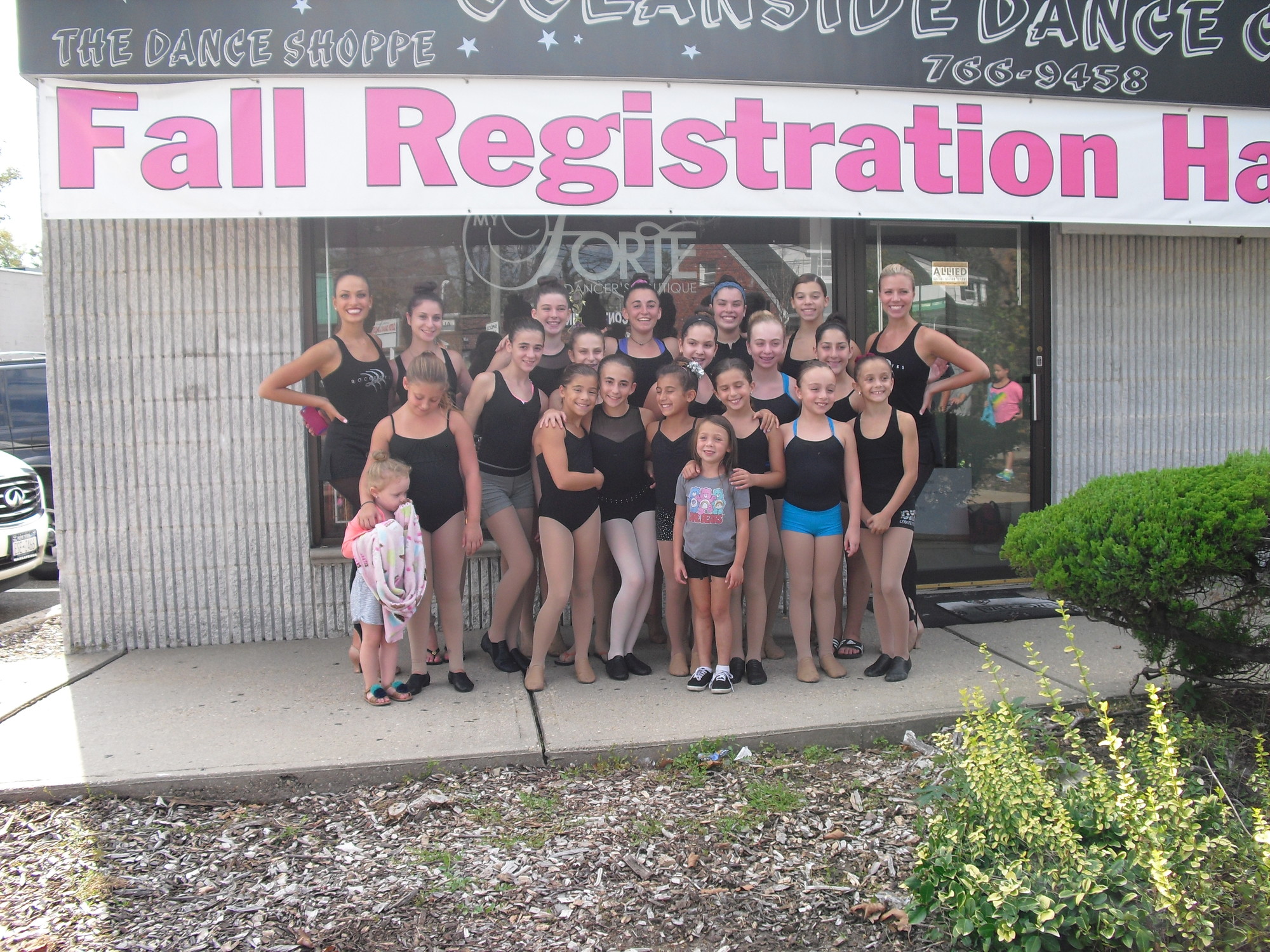Rockettes Eleni Gavalas, far left, and Tara Dunleavy, far right, and the dance students outside of the Oceanside Dance Center.