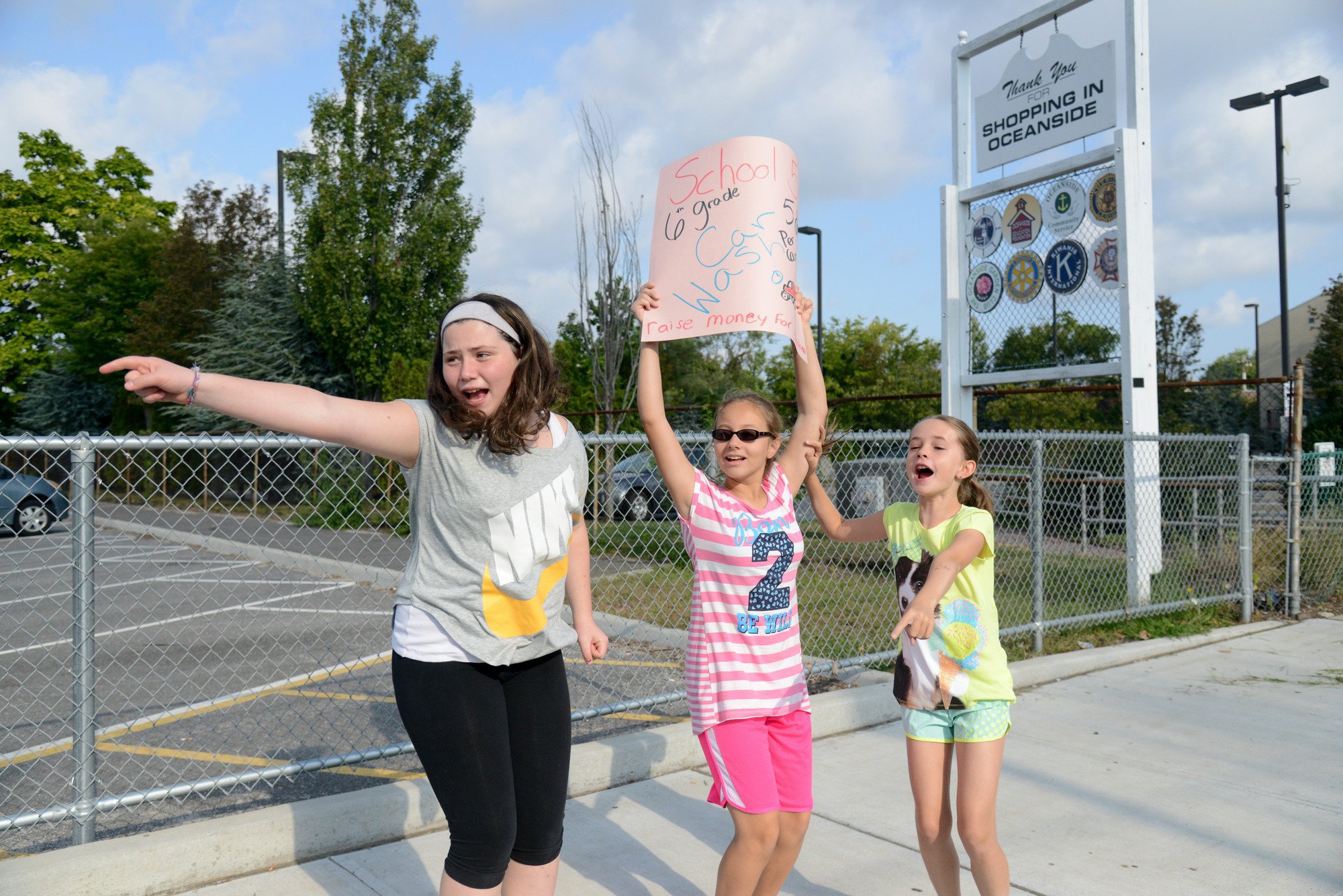 Sydney Nostramo, Miray Yildirim, and Jenna Cozier directed customers to the School No. 5 car wash on Sept. 20.
