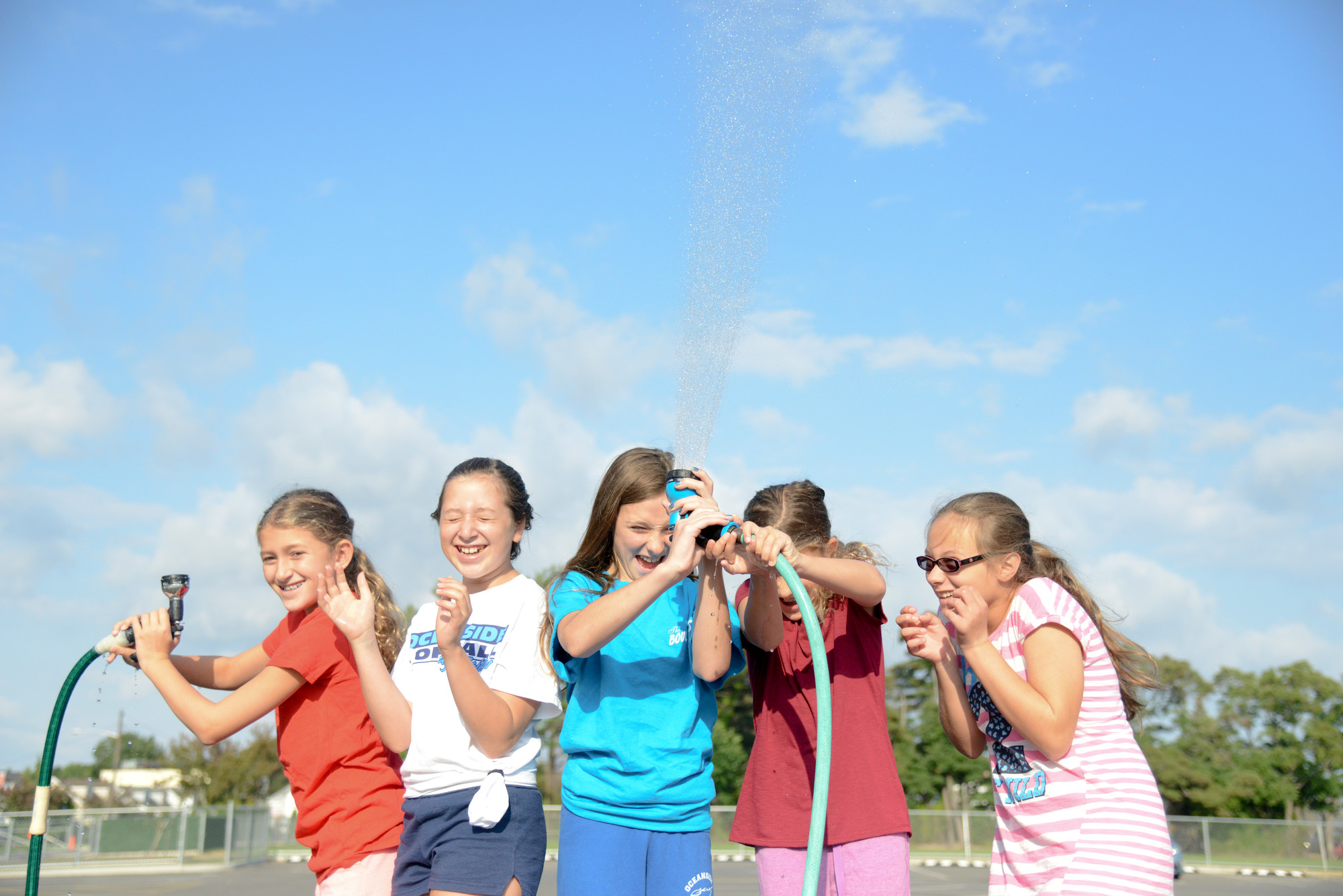 Halle Eviner, far left, Lindsay McFall, Kayla Powers, Meral Eviner and Miray Yildirim put the hoses to good use at the School No. 5 fundraiser last weekend.