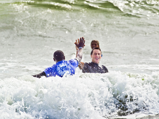 Balaram Stack, right, high-fived a participant of the “expression session” that paired 12 kids from the youth-focused nonprofit STOKED with 12 world-renowned professional surfers.