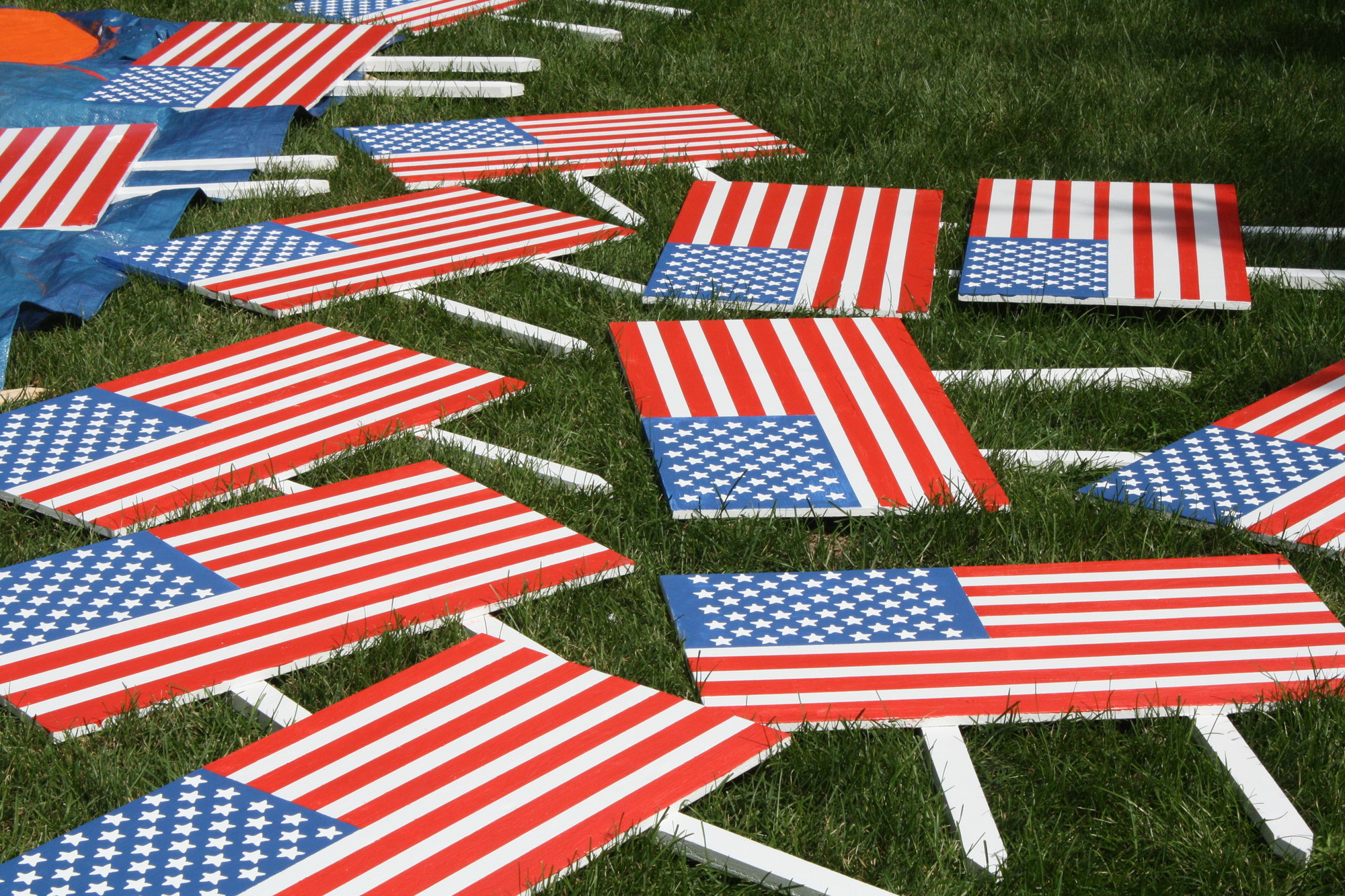 Many freshly painted American flag lawn signs were left out to dry in the sun.