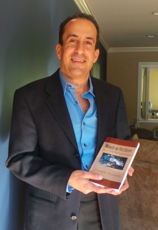 Joseph Parenti with his new book in his West Hempstead home last Friday. Parenti was involved in a near-fatal crash that left him hospitalized for seven months.