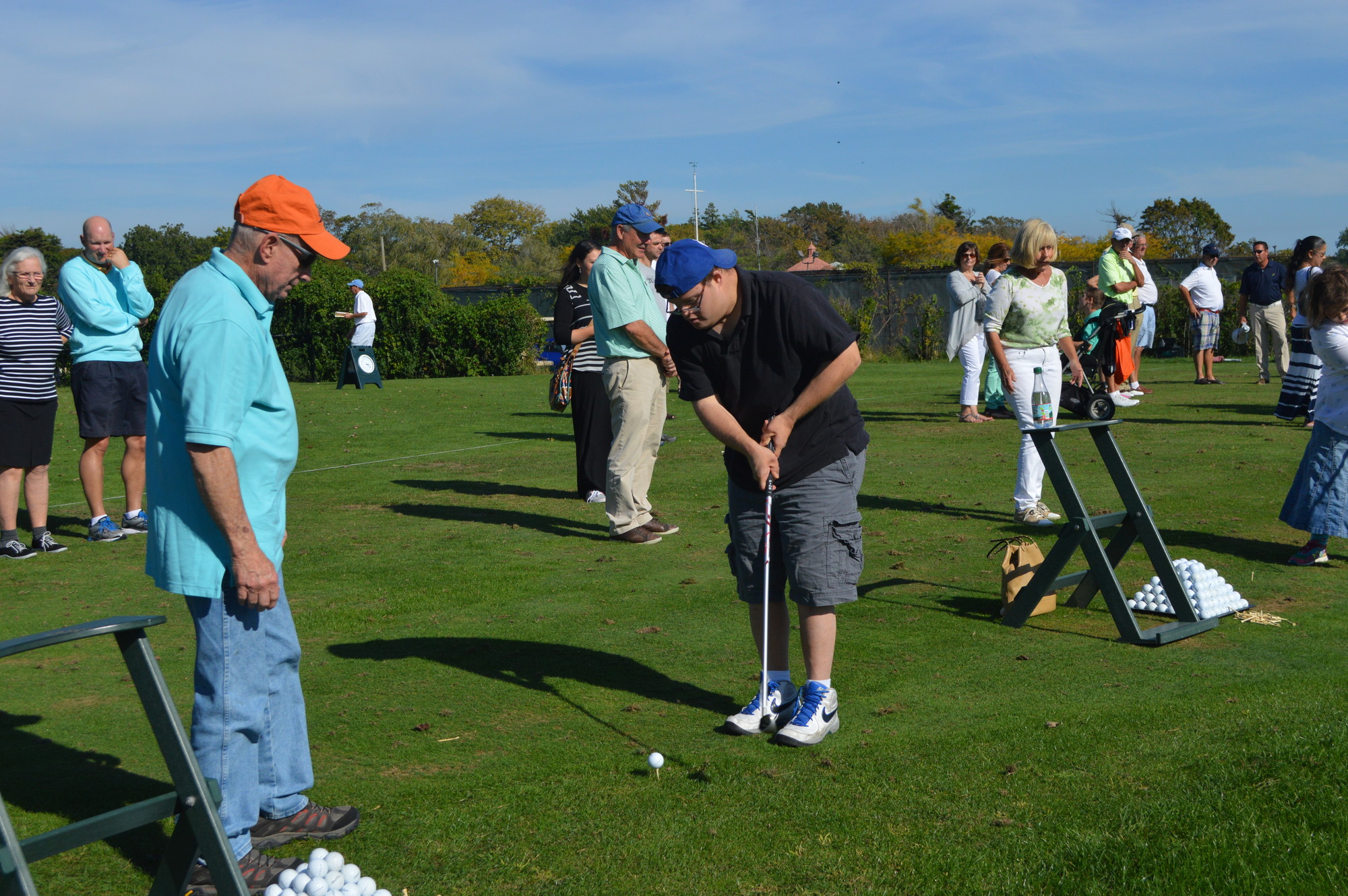 JCC’s “Play Golf” clinic provided the opportunity to learn how to play the game. Steve Hammerman, left, helped Adam Weingarten address the ball.