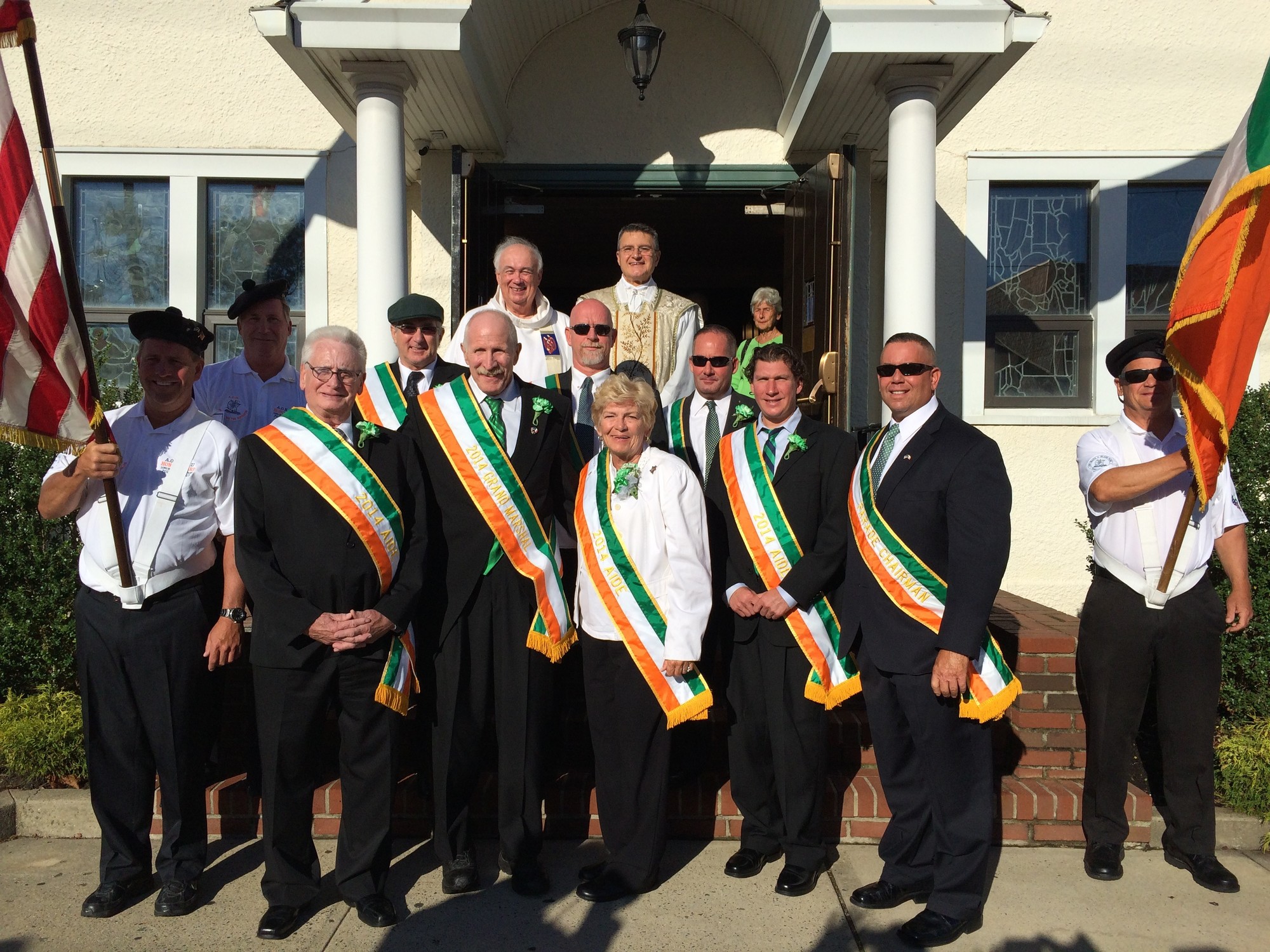 2014 AOH Irish Day parade honorees, Roy Doyle, third from left, Bill Treadway, Grand Marshal Randy Dodd, AOH Division 17 President Joseph Moran, Ladies’ AOH Diane Hagen, Danny Ryan, Darren Siff, and AOH Division 17 Parade Chairman Bernie Petty. Top row: Msgr. Donald Beckman and Father John Tutone.