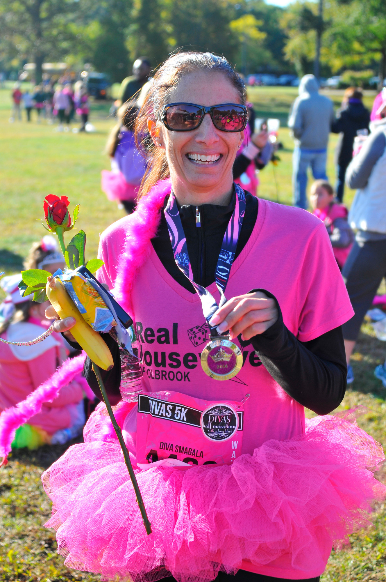 Dena Smagala of Holtsville proudly shows off her medal at the end of the race, which was awarded to each race finisher.