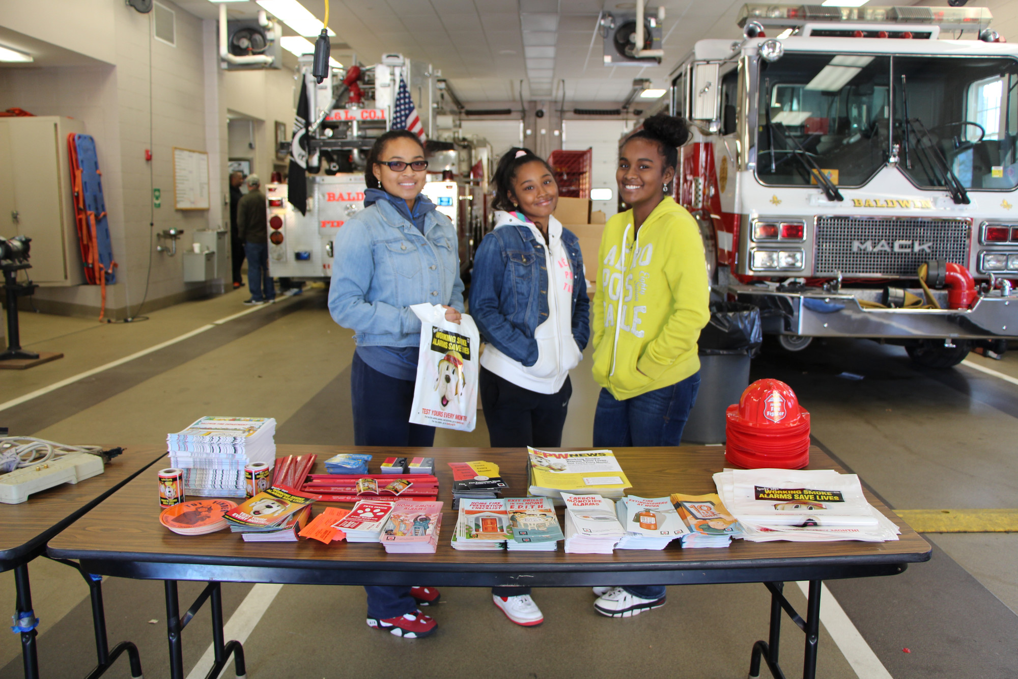 Family members of the BFD helped distribute information and hemlets to the children and residents. From left were Matinash Cesar, 15, Meylyne Cesar, 13, and Maurine Cesar, 12.