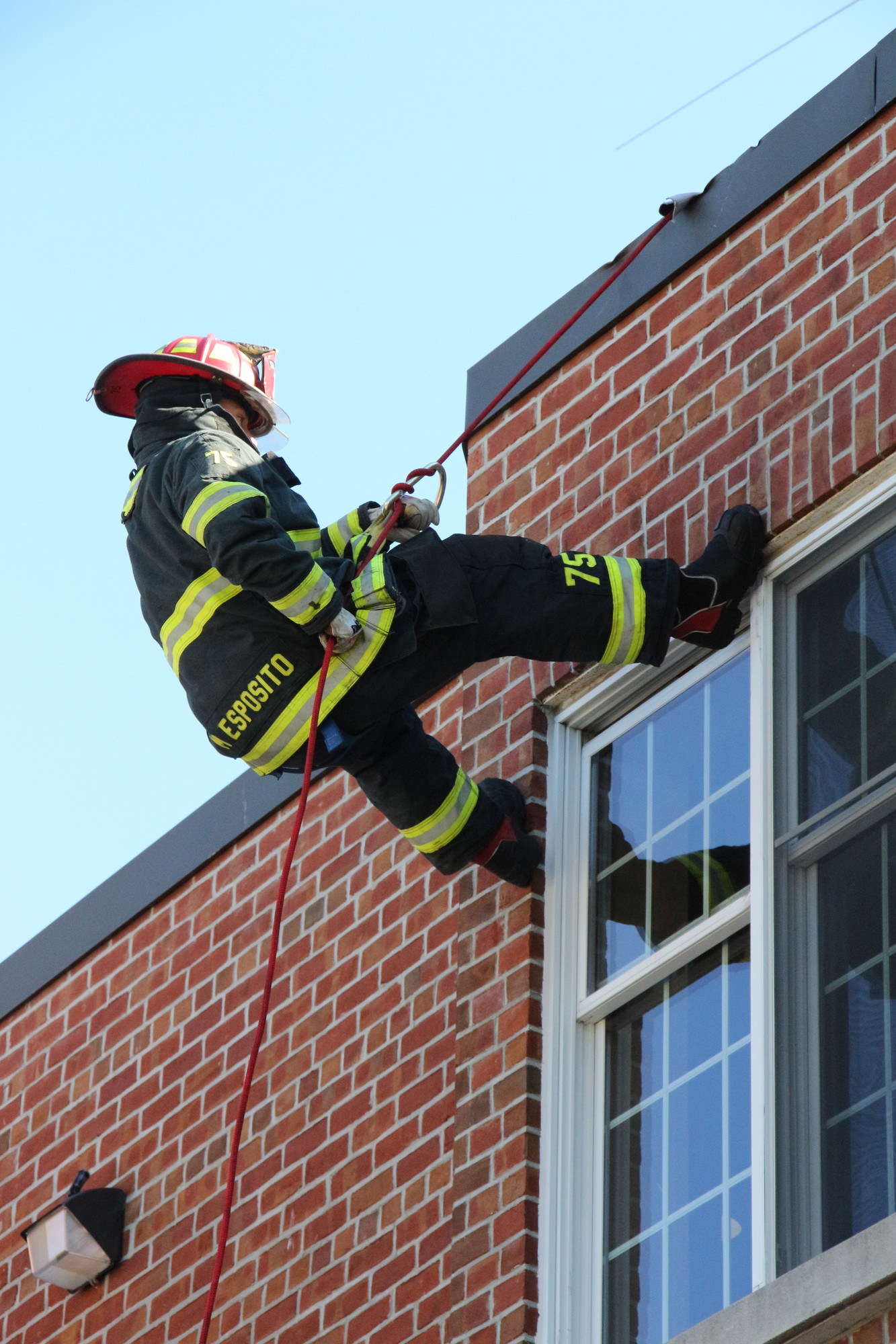 Fireman Michael Esposito demonstrated how firefighters rappel down the side of a building.