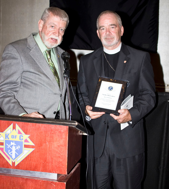 Rev. Mark Lukens accepted his award from Kiwanian Richard Meagher.
