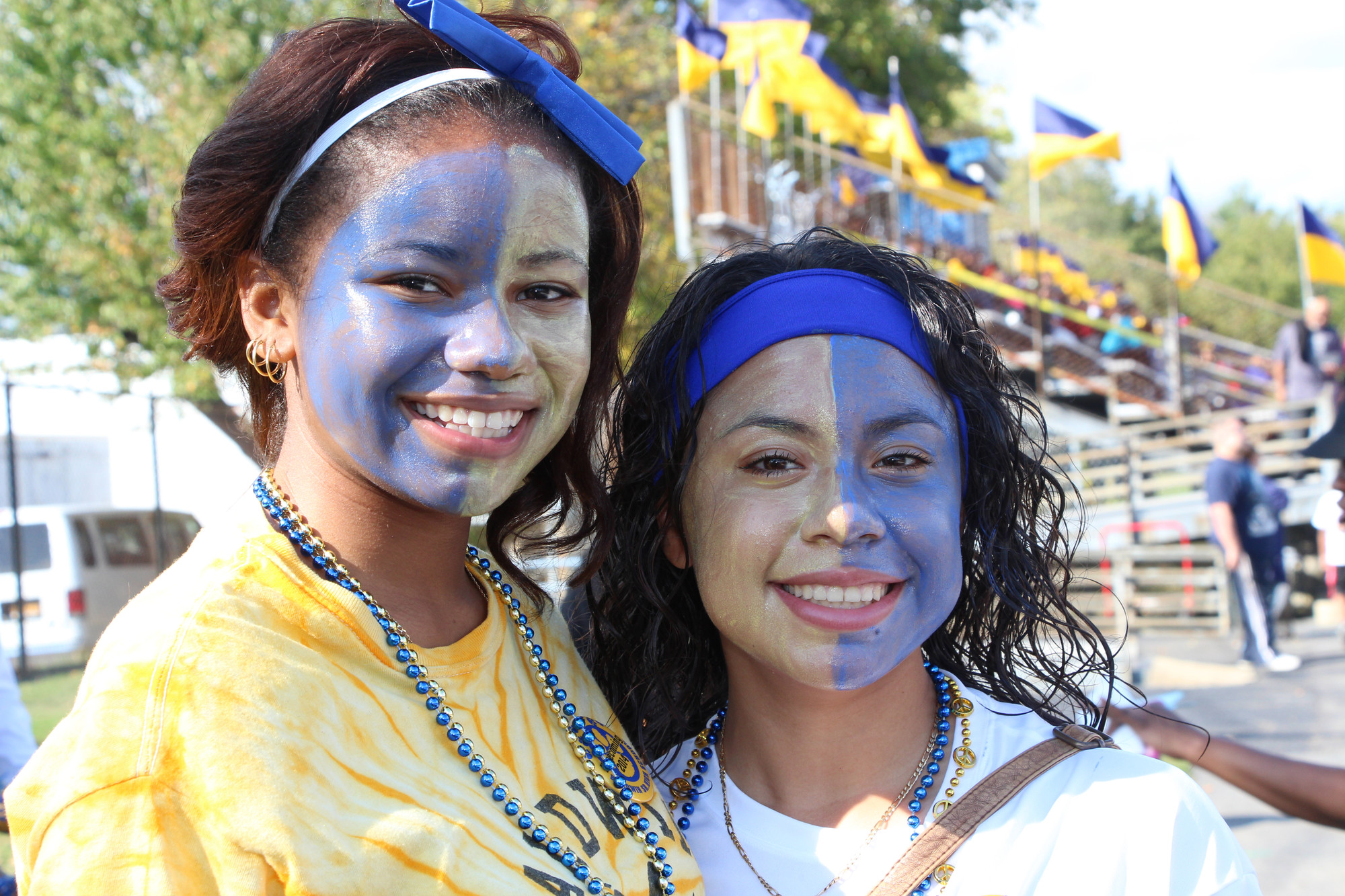 Students showed their School spirit during the Homecoming game.  Claudia Martines, 15, left, and Ashantis Jamieson,15, had their faces painted in the school’s colors, blue and gold.