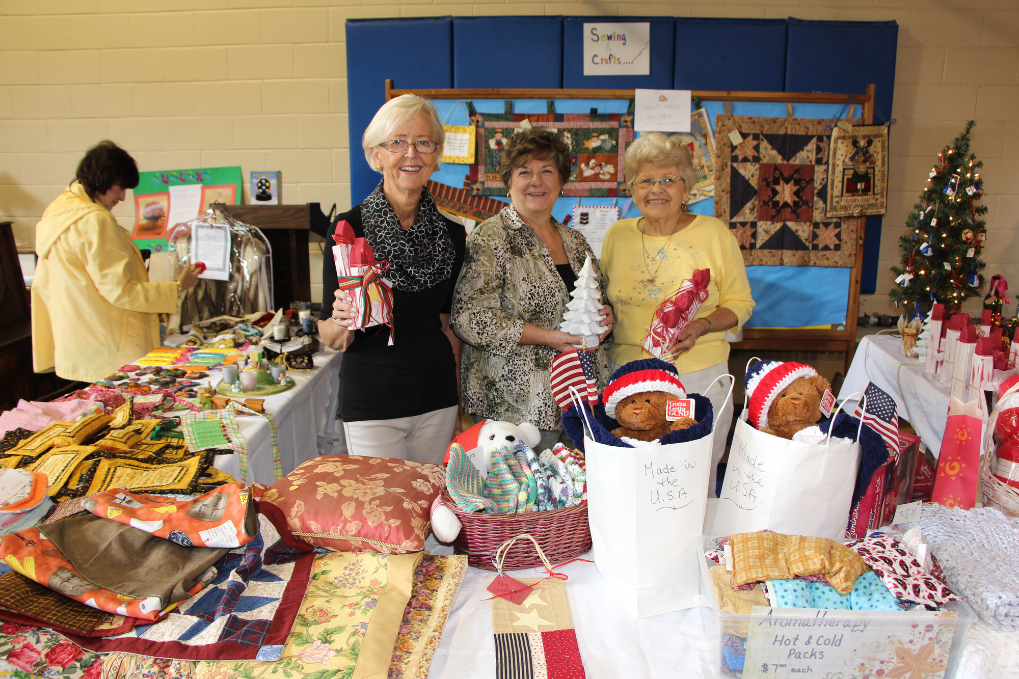 Brit Birkelund, left, Eileen Dubnham, center, and Arylnn Streithorst had many holiday crafts and home decorations available for purchase.