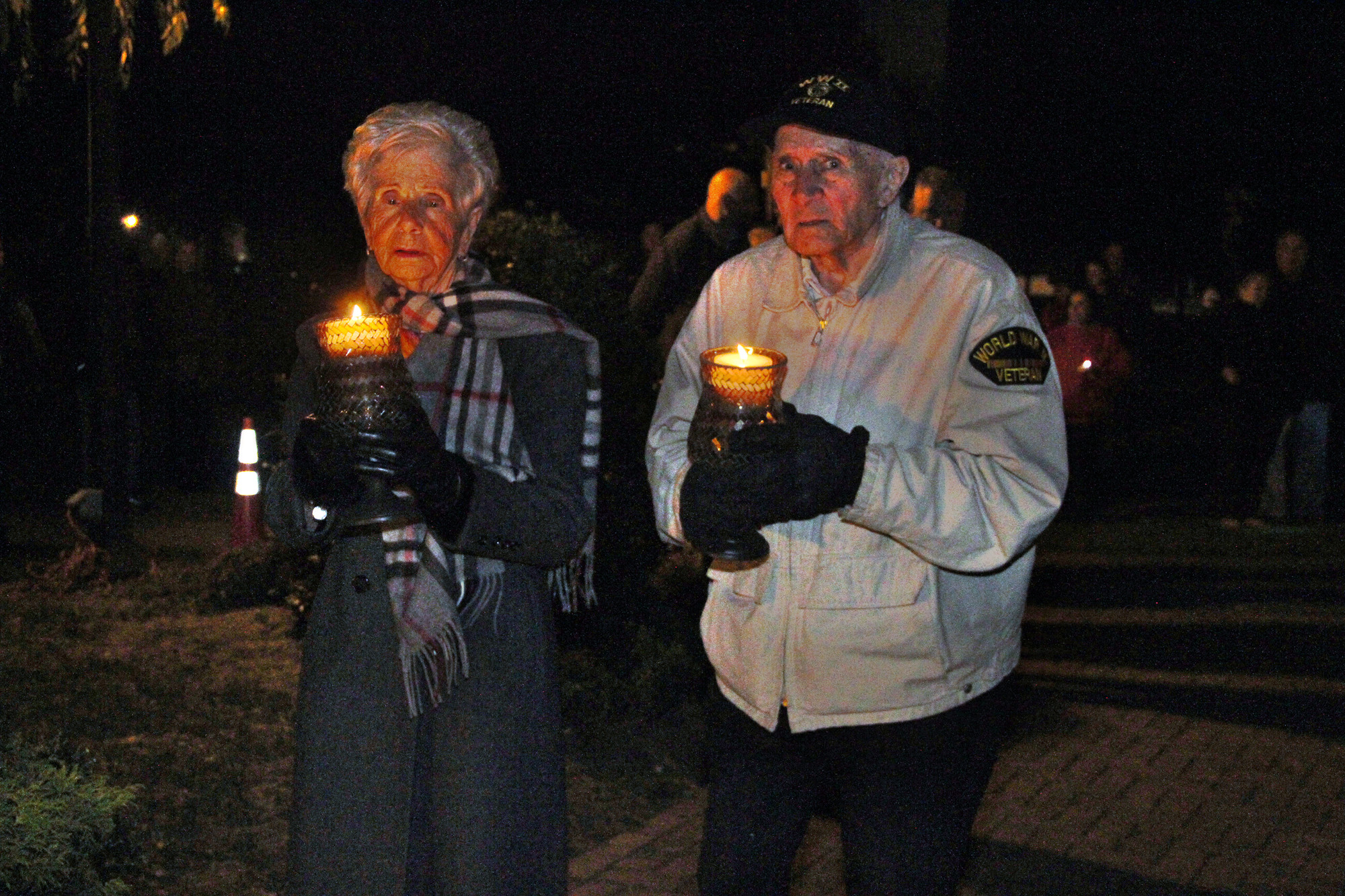 Mary Ann and Frank Sherry placed candles on the village’s memorial in honor of their son, John Anthony, who died in the attacks.