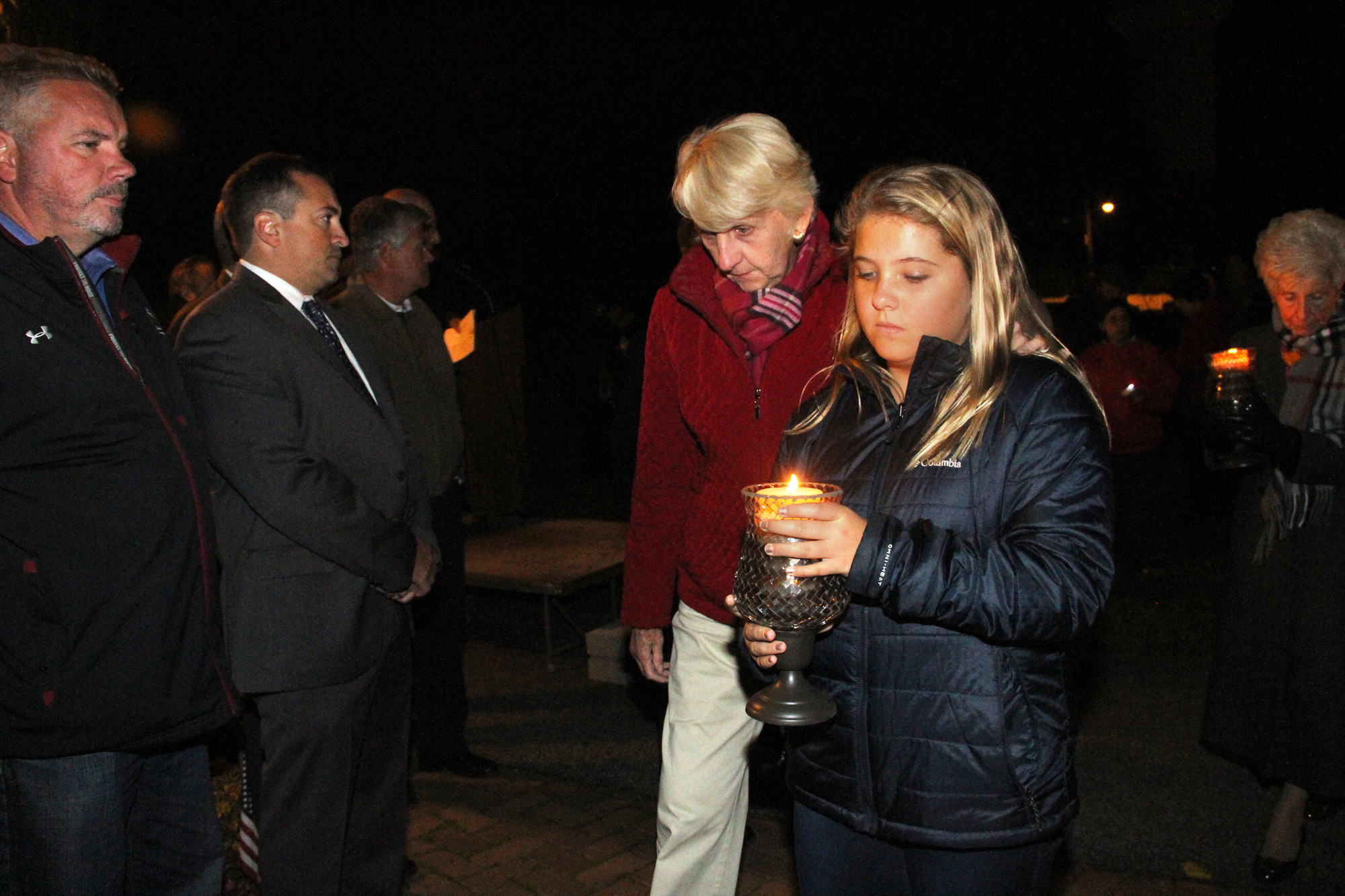 Members of the Logler family brought candles to the memorial ceremony.