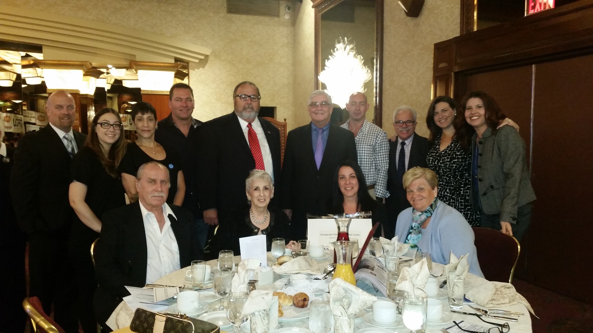 Shannon McComb, seated second from right, celebrated her win as the Rockville Centre Businessperson of the Year at the Crest Hollow Country Club on Oct. 17. She was joined by other members of the Chamber of Commerce and Rockville Centre Mayor Francis X. Murray, standing fifth from left.