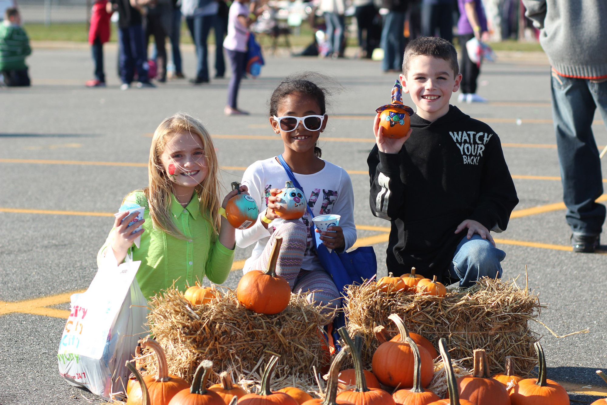 Olivia Guerriere, left, Jasmin Tiong-Smith, and Jason Brady, all 8 showed off their pumpkins.
