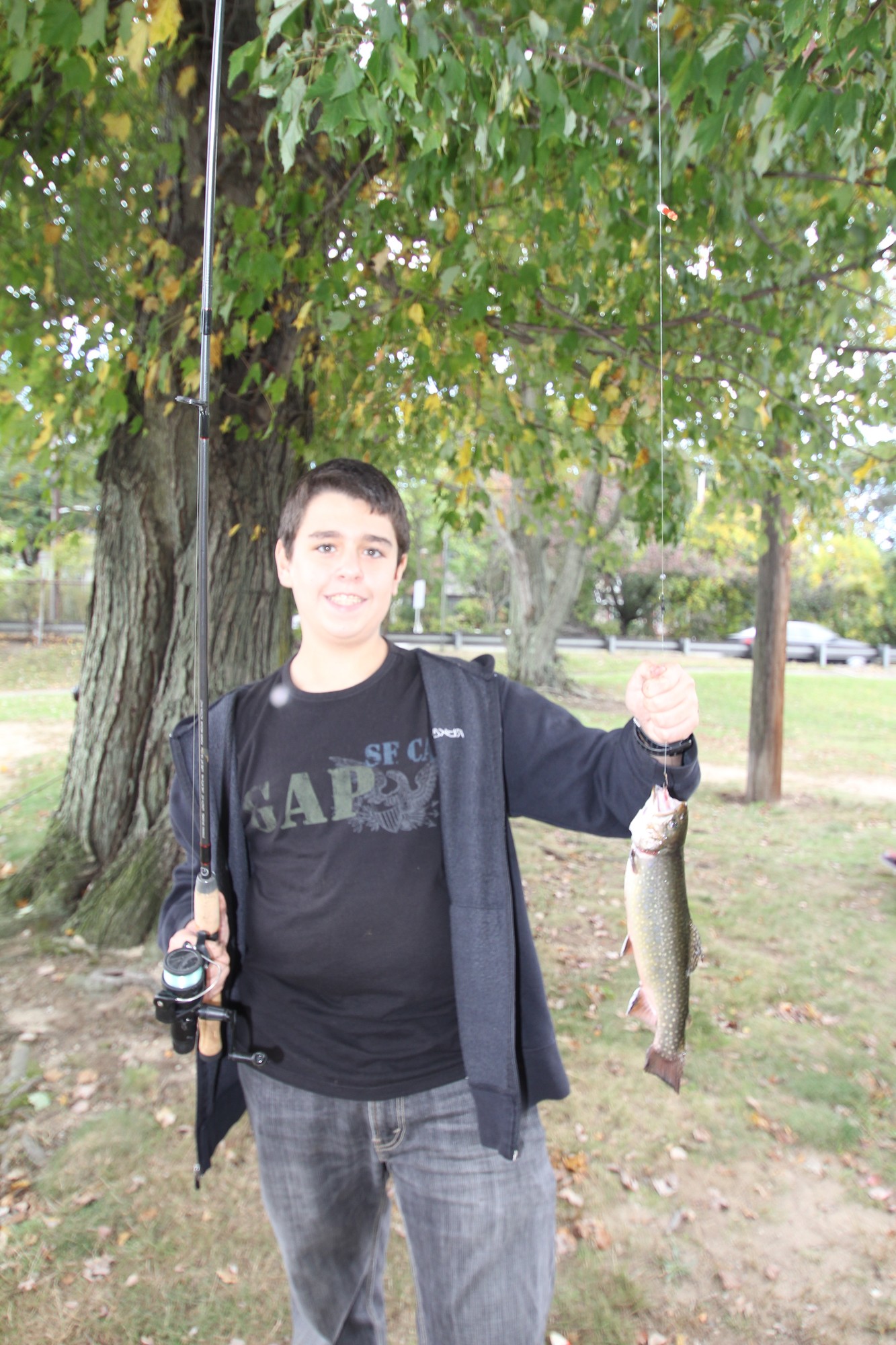 Aaron Stemt proudly displayed the brook trout he caught.