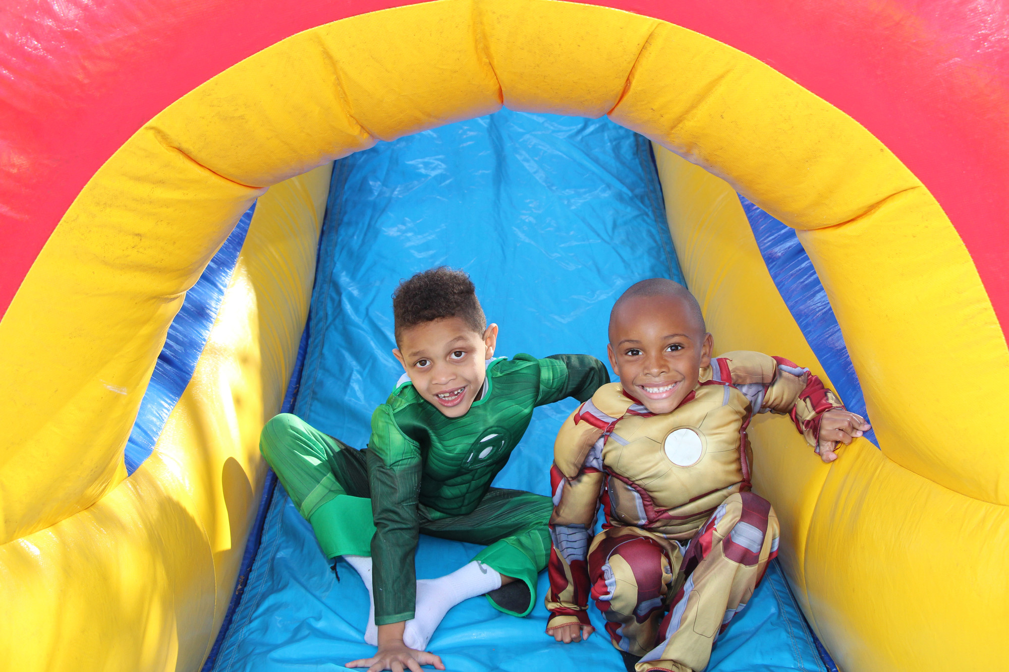 Tristan Botknight, 6, near left, and Jalil Jones,7, dressed up as their favorite crime-fighting heroes before they hopped around inside the bouncy house at the Halloween Fest in Milburn Park last Saturday.