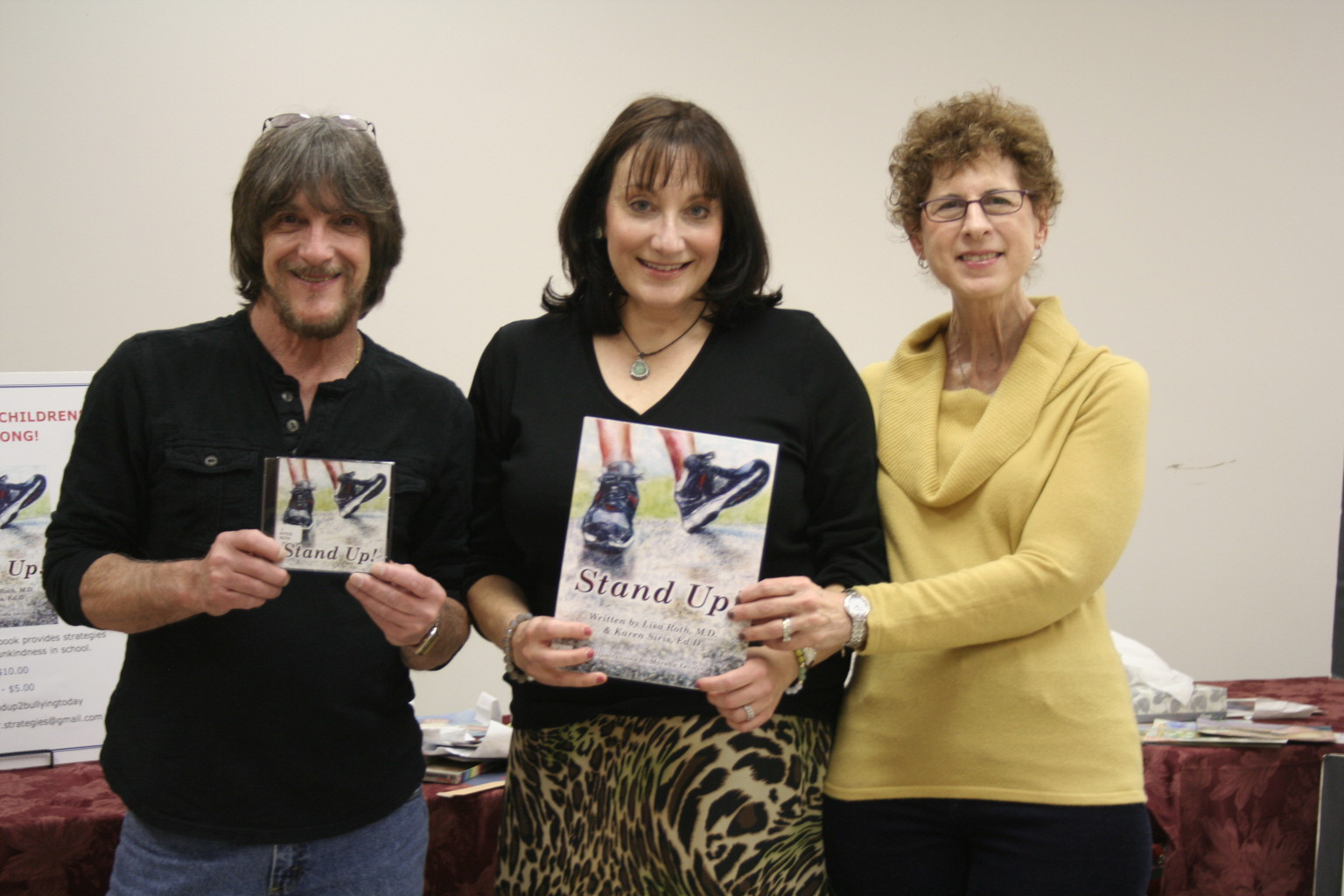 Lisa Roth, center, held a book signing at the East Rockaway Library for “Stand Up!” She was joined by musician Paul Lanzetta, left, of East Rockaway Music, who wrote the accompanying song, and the book’s illustrator, art teacher Marsha Letvin, at right.