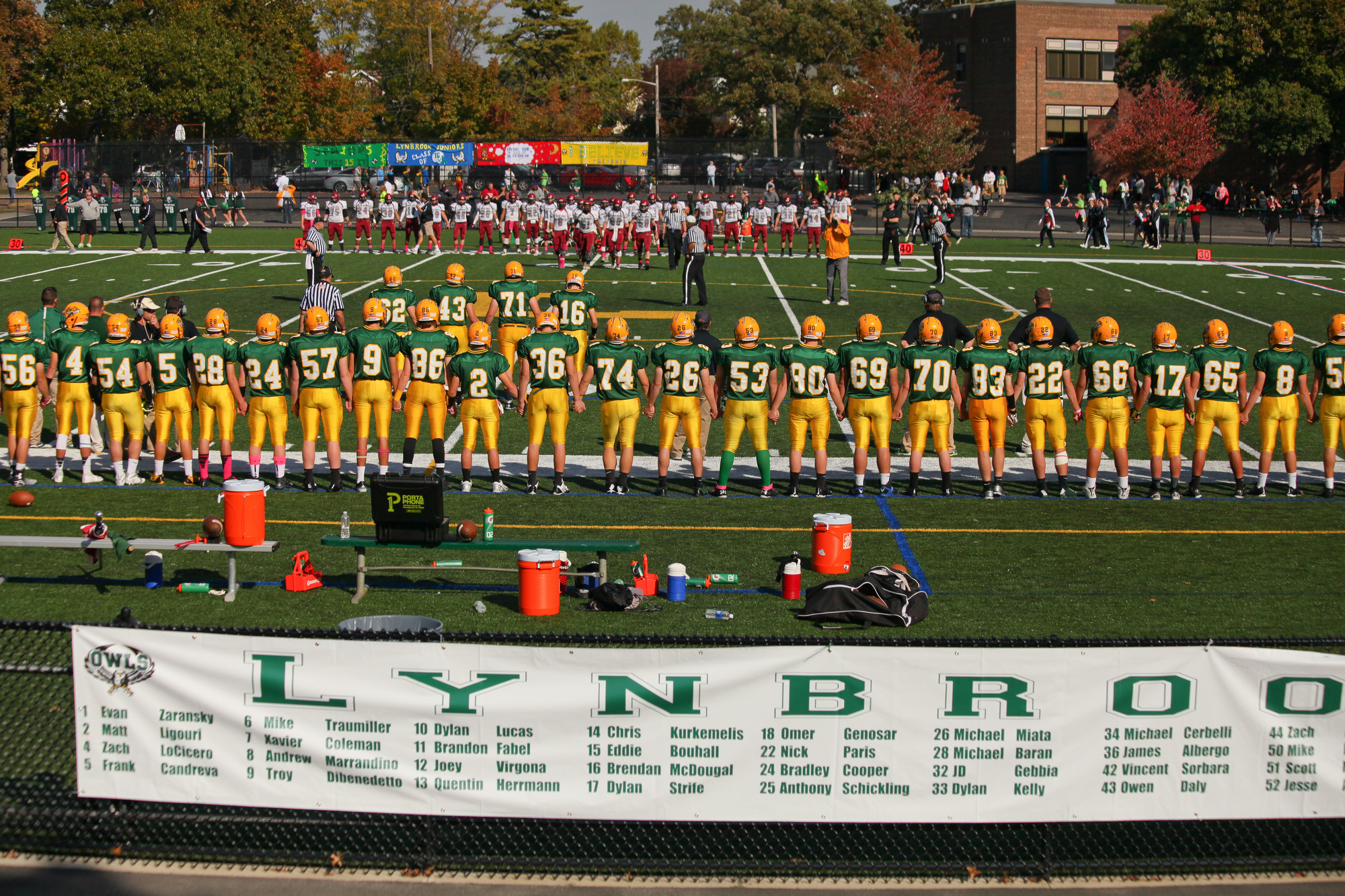 Lynbrook and Glen Cove line up for the coin toss before the start of the game.