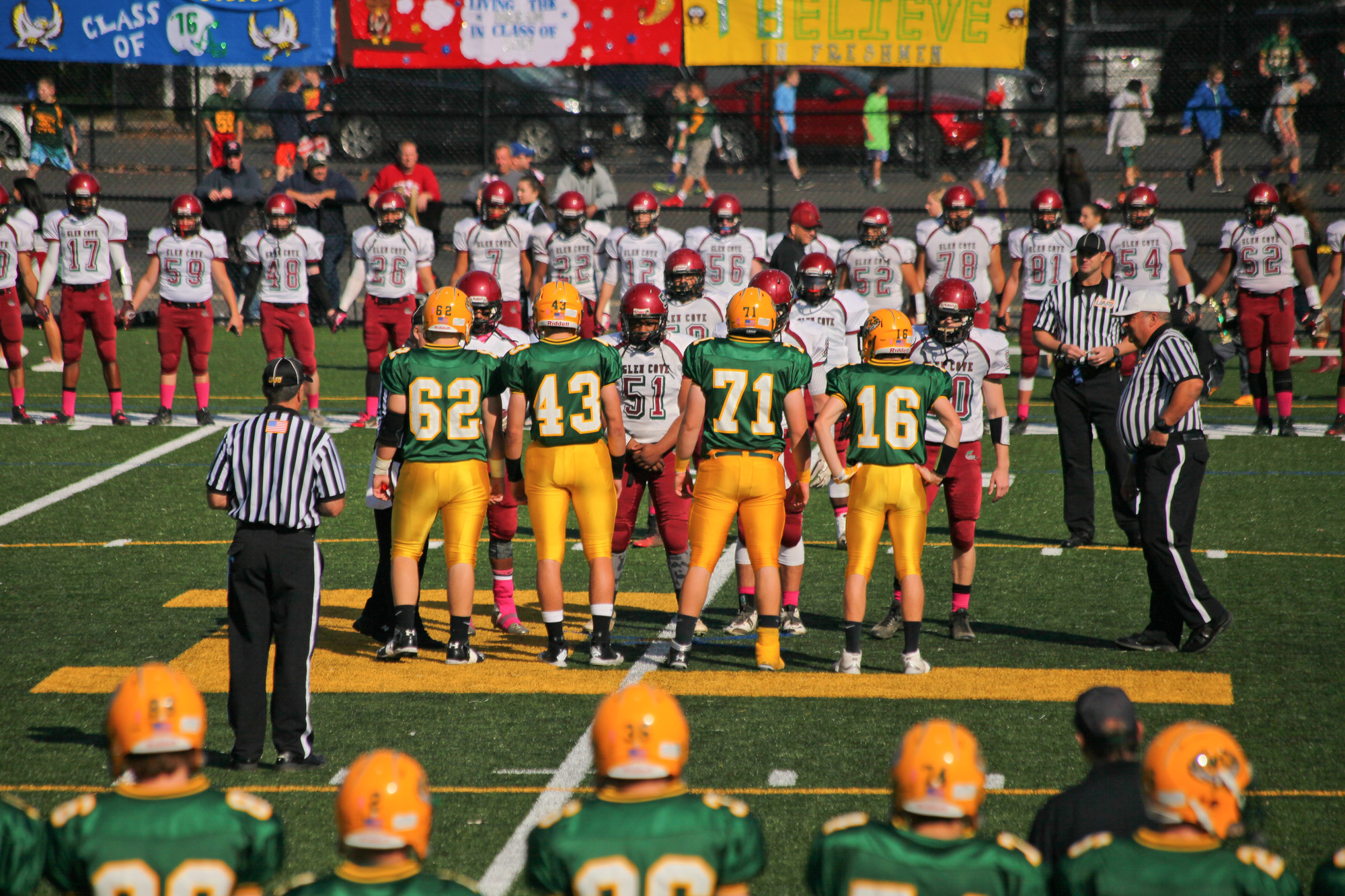 Lynbrook and Glen Cove line up for the coin toss before the start of the game.