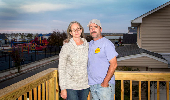 Michelle and Tim Kelly on the deck of their new home on Harmon Street. The Kellys moved into their reconstructed — and elevated — home on Saturday.