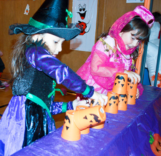 Brianna Hnriques, left, and Alyssa Alexander competed against each other in the Halloween cup stacking competition.