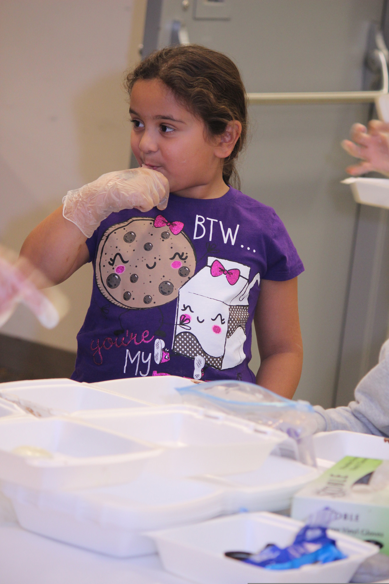 Caitlyn Membreno,7, had a quick taste at the decorating station.