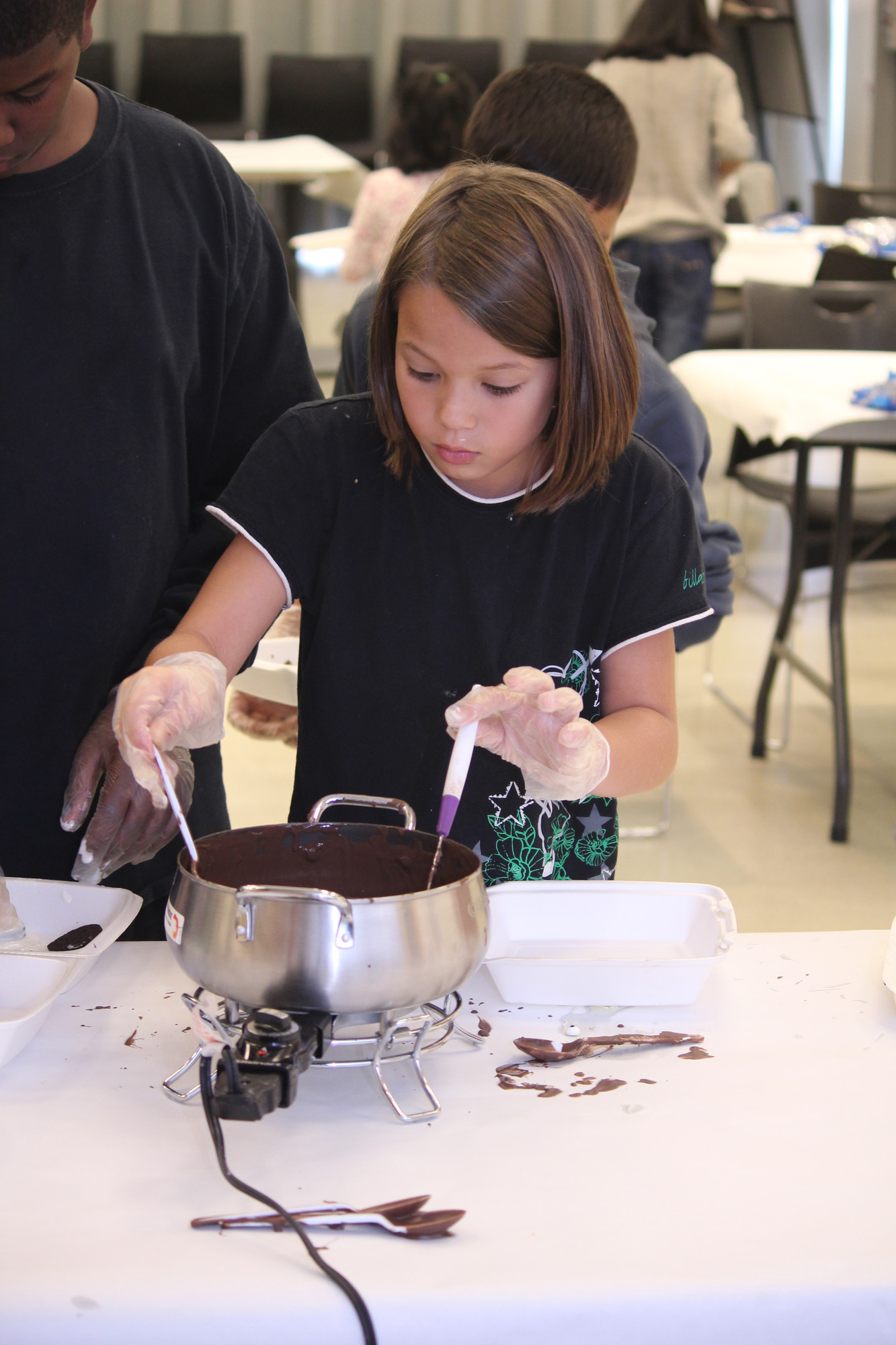 Caroline Lozada, 9, scooped out her oreo from the melted chocolate.