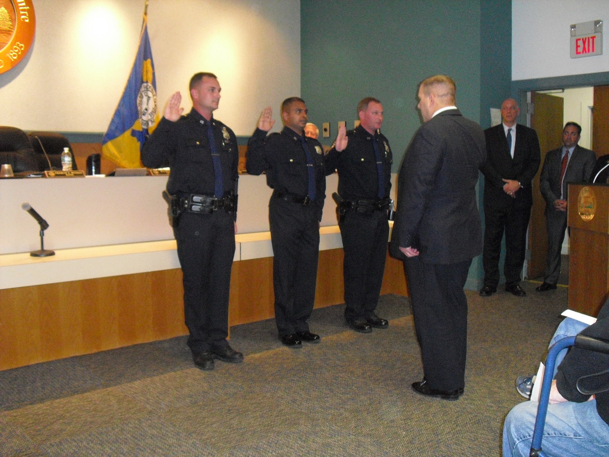Police Commissioner Charles Gennario, right, swore in, from left, John Murphy, Sal Thomas and Cory Bloch as new officers.