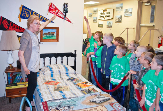 Second-graders from East Broadway Elementary School visited the Levittown Historical Museum on Nov. 6, where docent Geri Raab showed them a typical child’s bedroom in a Levitt home.