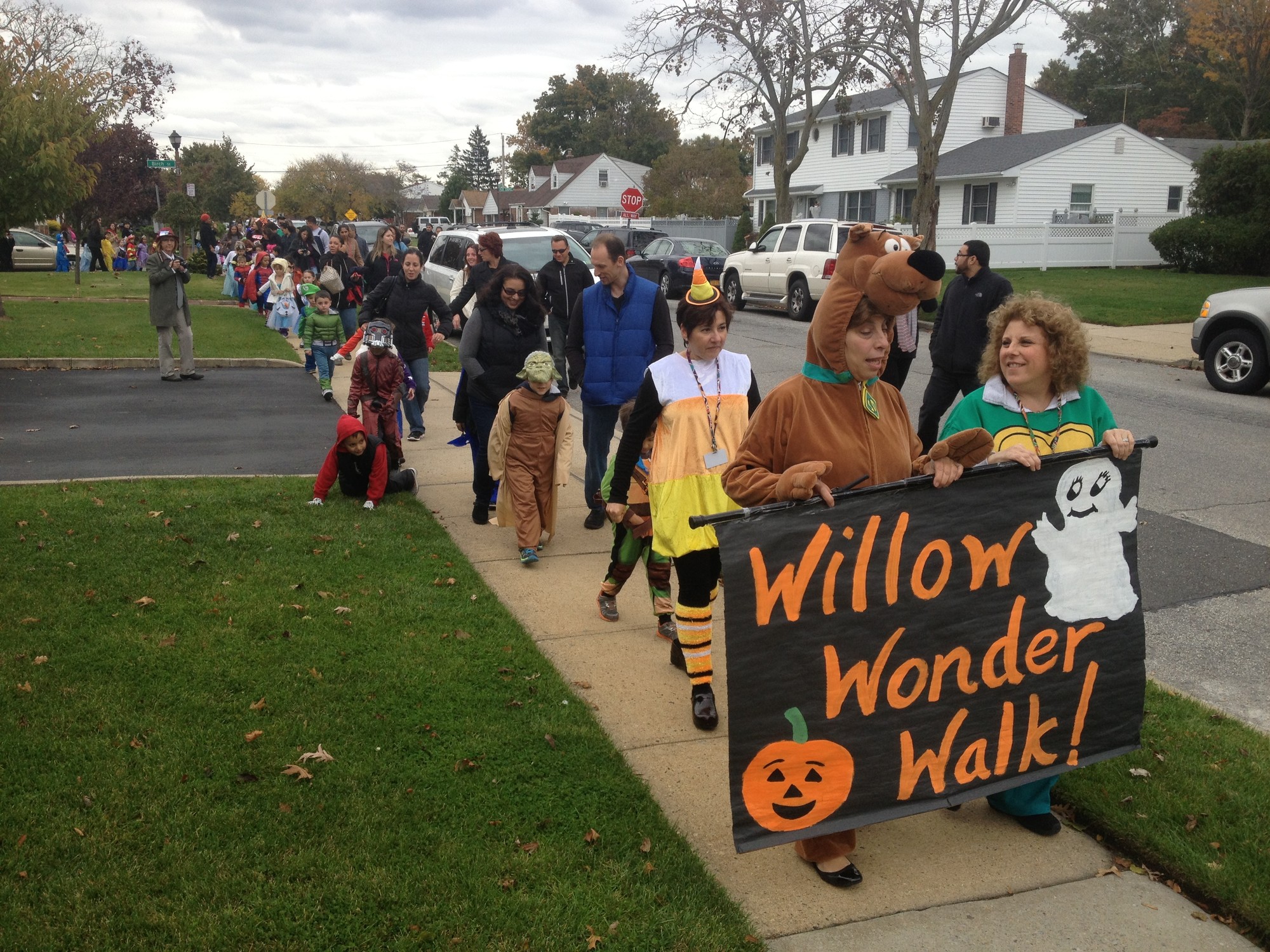 Principal Stephanie Capozzoli, as Snoopy, and kindergarten teacher Vita Tringone, right, lead the Willow Wonder Walk, which benefits the March of Dimes organization.