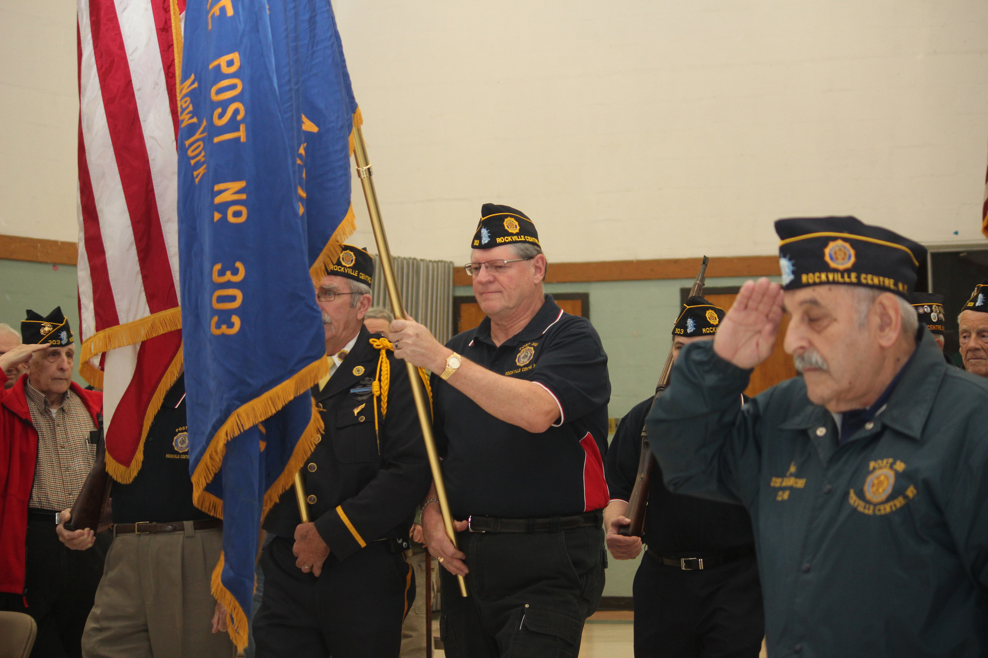 Photos by Theresa Press/Herald
The American Legion Post 303 Color Guard started the ceremony. Vietnam veteran Michael Lapkowski,left, carried in the American flag while fellow Vietnam veteran Walter Paruch carried the Legion’s blue flag..