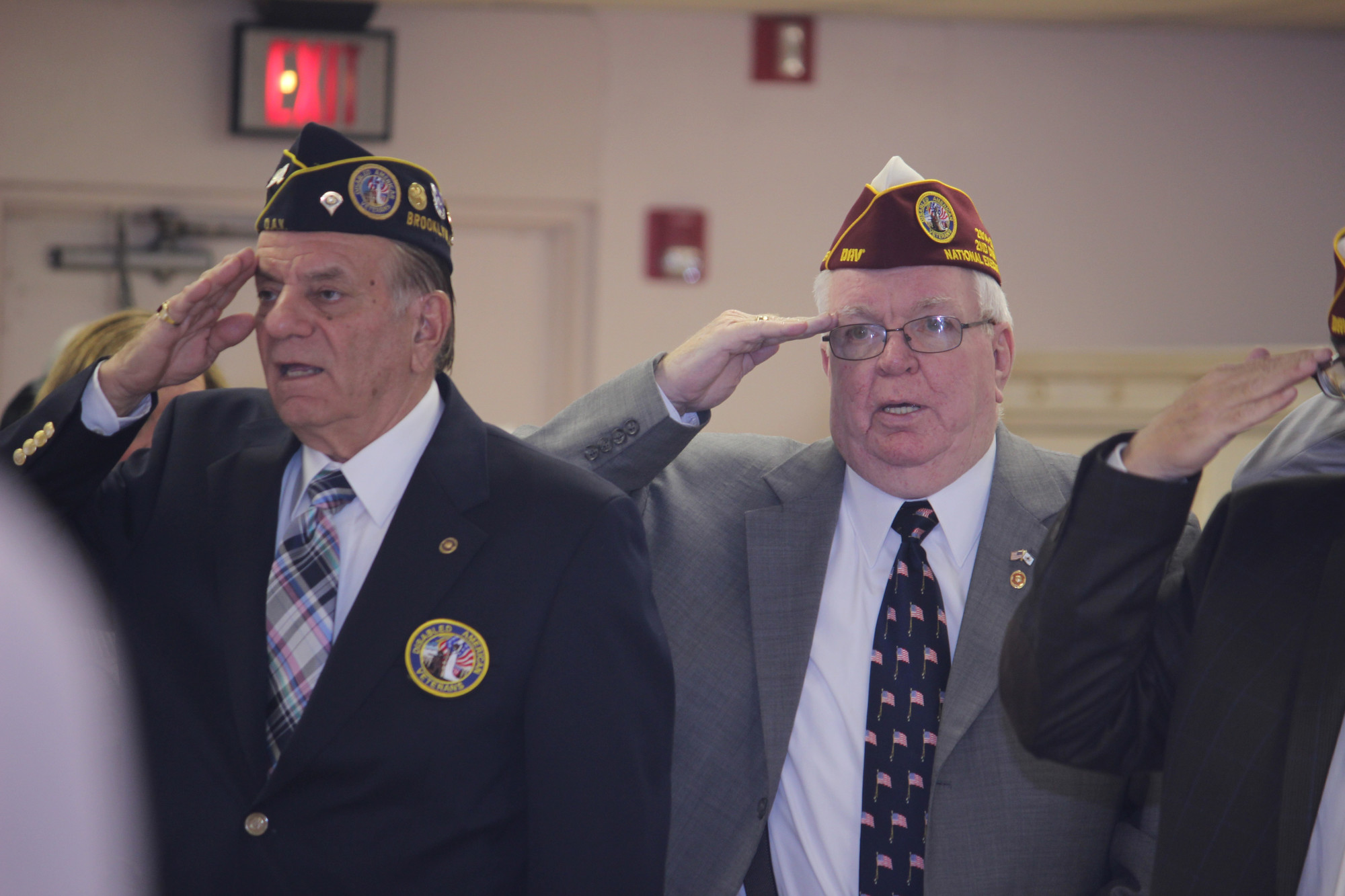 L Army veterans Tom Ingram, left, and Robert Finnerty saluted the flag during a ceremony before the luncheon at the Sandel Senior Center.