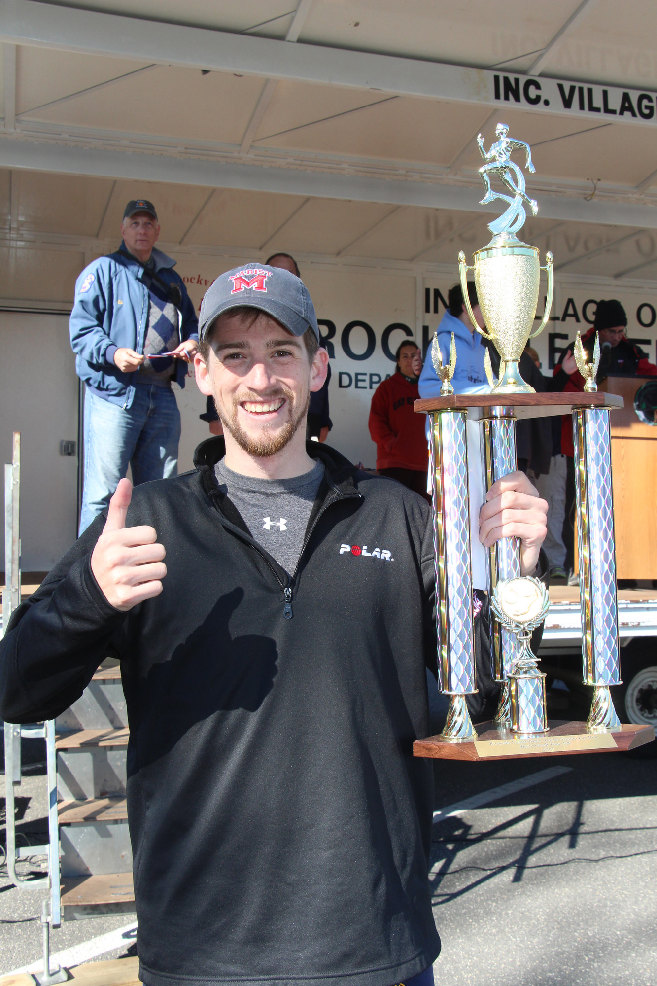 Rockville Centre resident Conor Shelley proudly showed off the trophy he won for finishing first in the 10K.