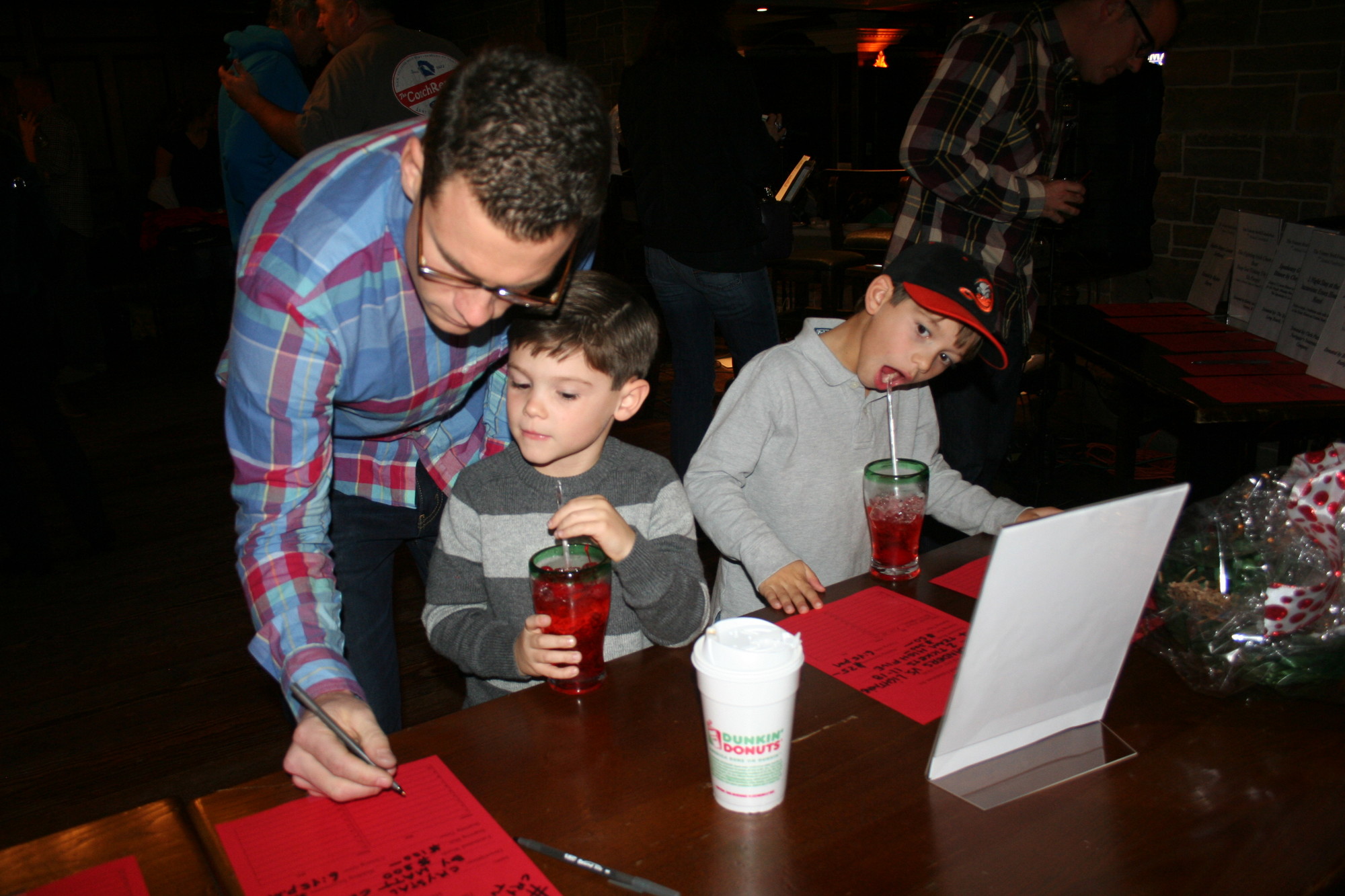 Rob McCracken signed up for a raffle with his son Jamie, left, and nephew T.J. Brull.
