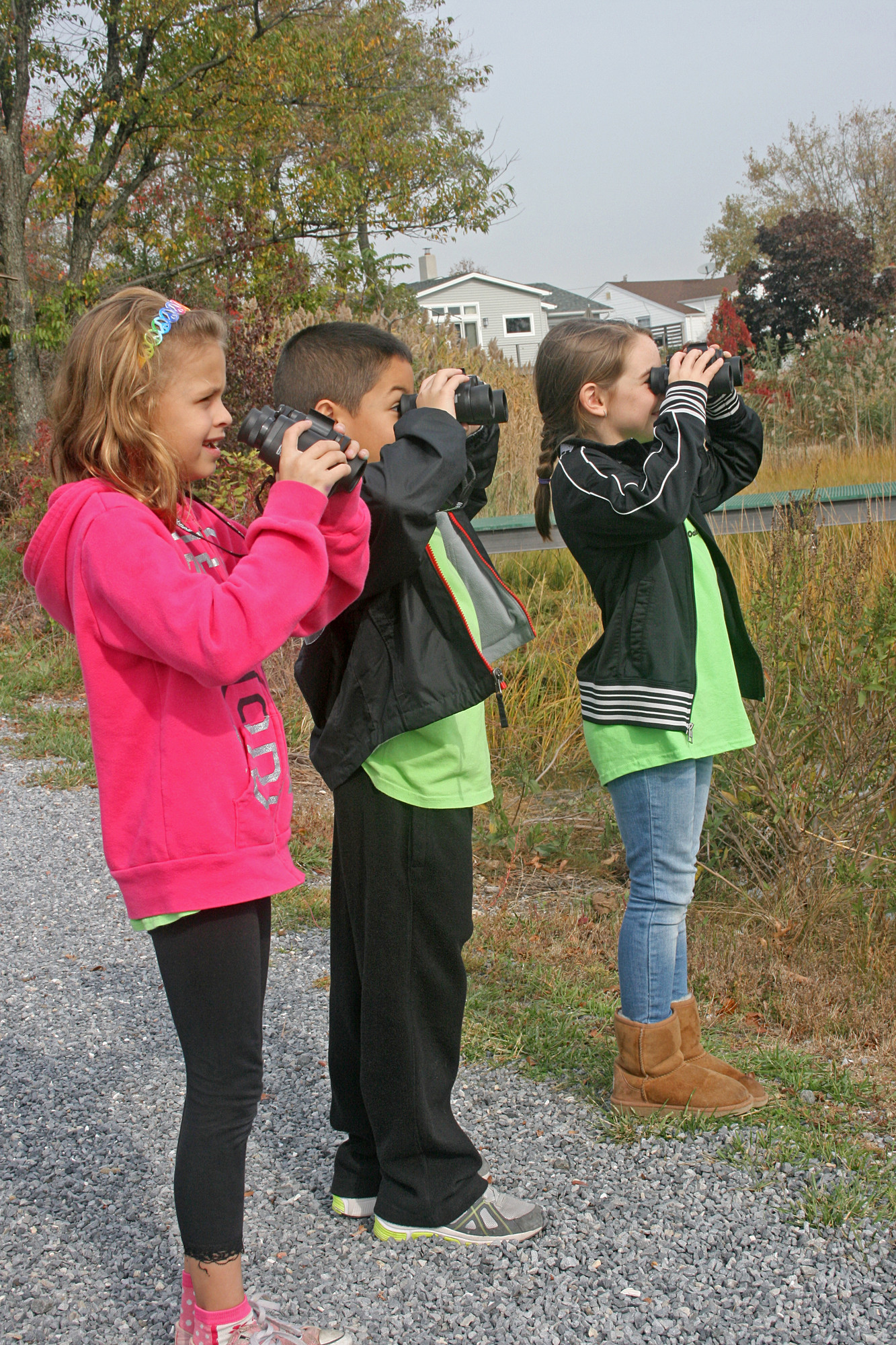 Brigid Mahoney, Christopher Rubio and Karen Scarola of School #3 use binoculars at a grade-three trip to the Oceanside Marine Nature Study Area.