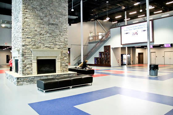 The lobby of the Twin Rinks Ice Center features a fireplace with comfortable seating.