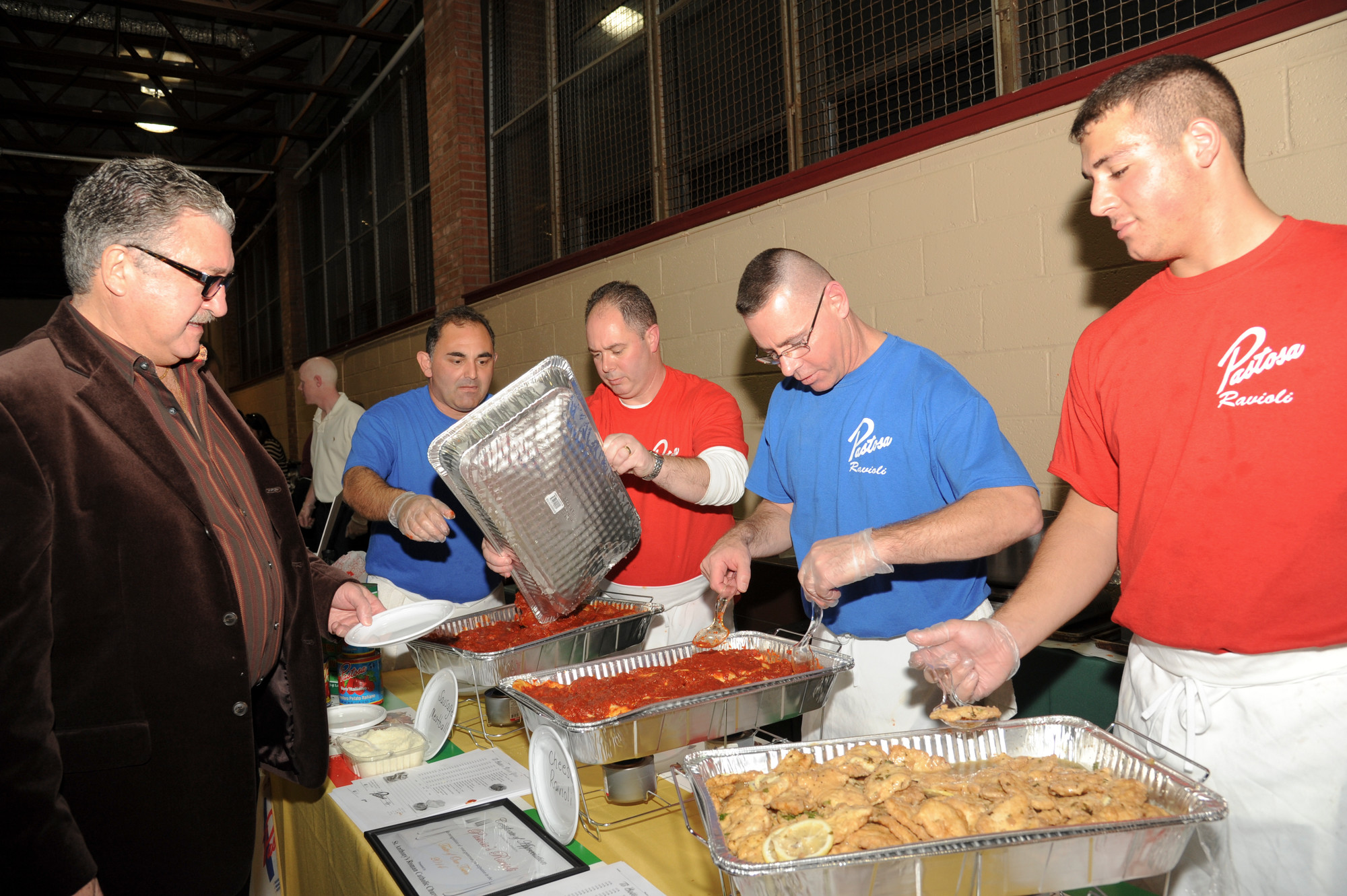 Tom Lanning, center, made sure that visitors to St. Anthony’s got a taste of Pastosa Ravioli.