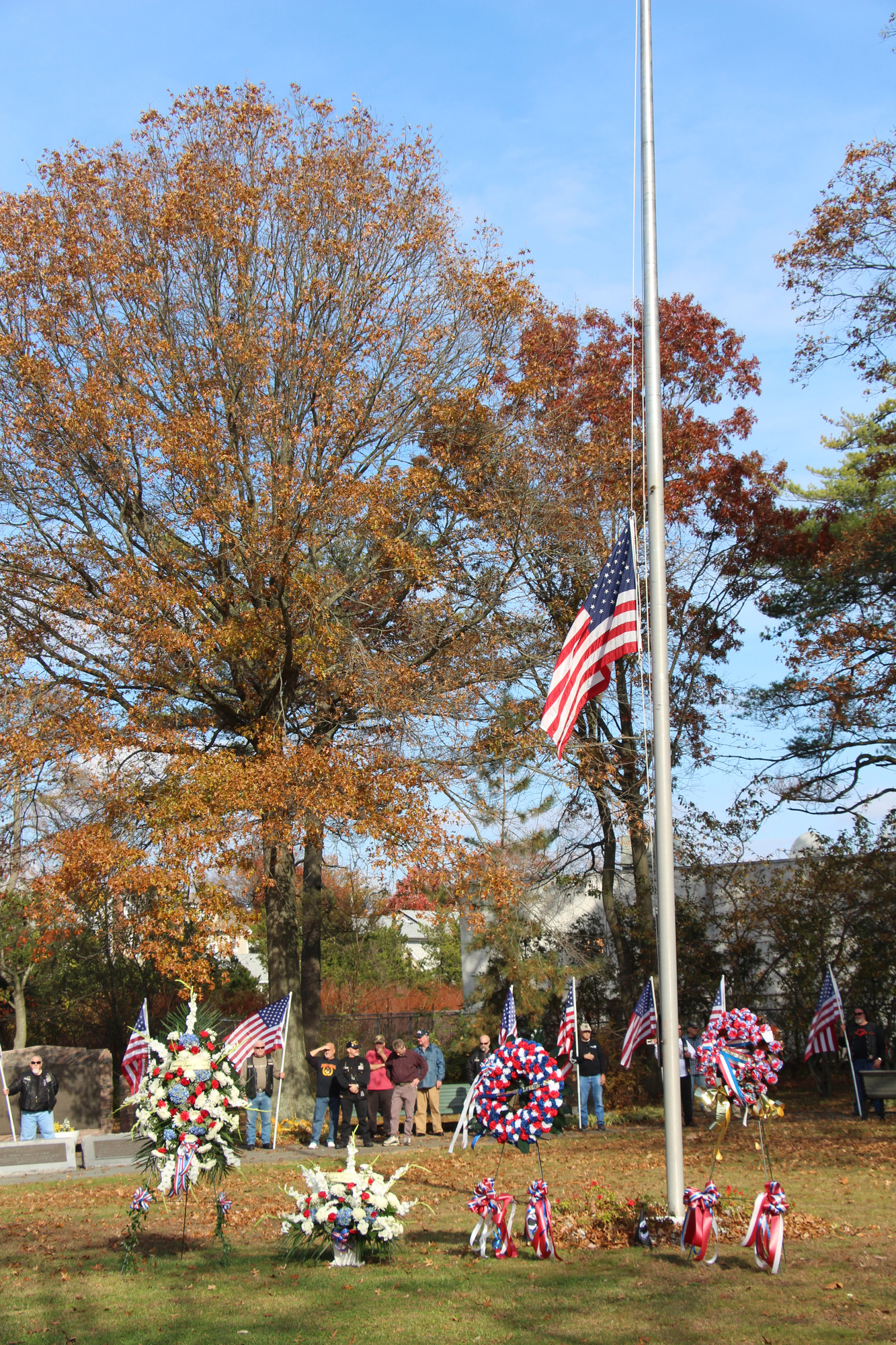 Wreaths were placed by the base of the flag pole.