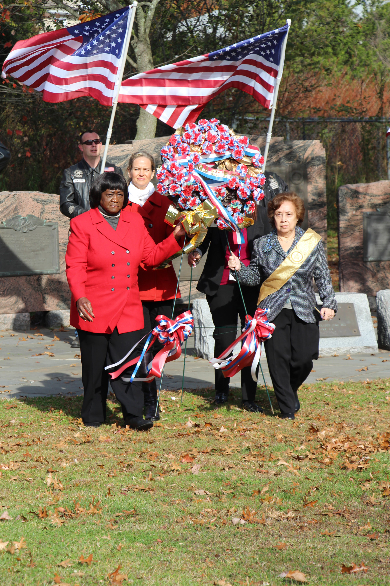 Gold Star mother Jeanette Urbina, right, with the assistance of, from left, Town of Hempstead Councilwoman Dorothy Goosby, Legislator Laura Curran and Debbie Pugliese, behind wreath, placed a wreath during the ceremony.