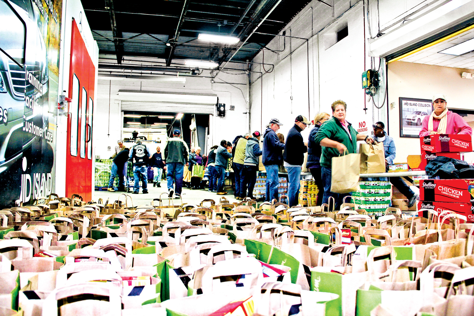 Last year, hundreds of people helped pack thousands of pounds of food at Mid-Island Collision.