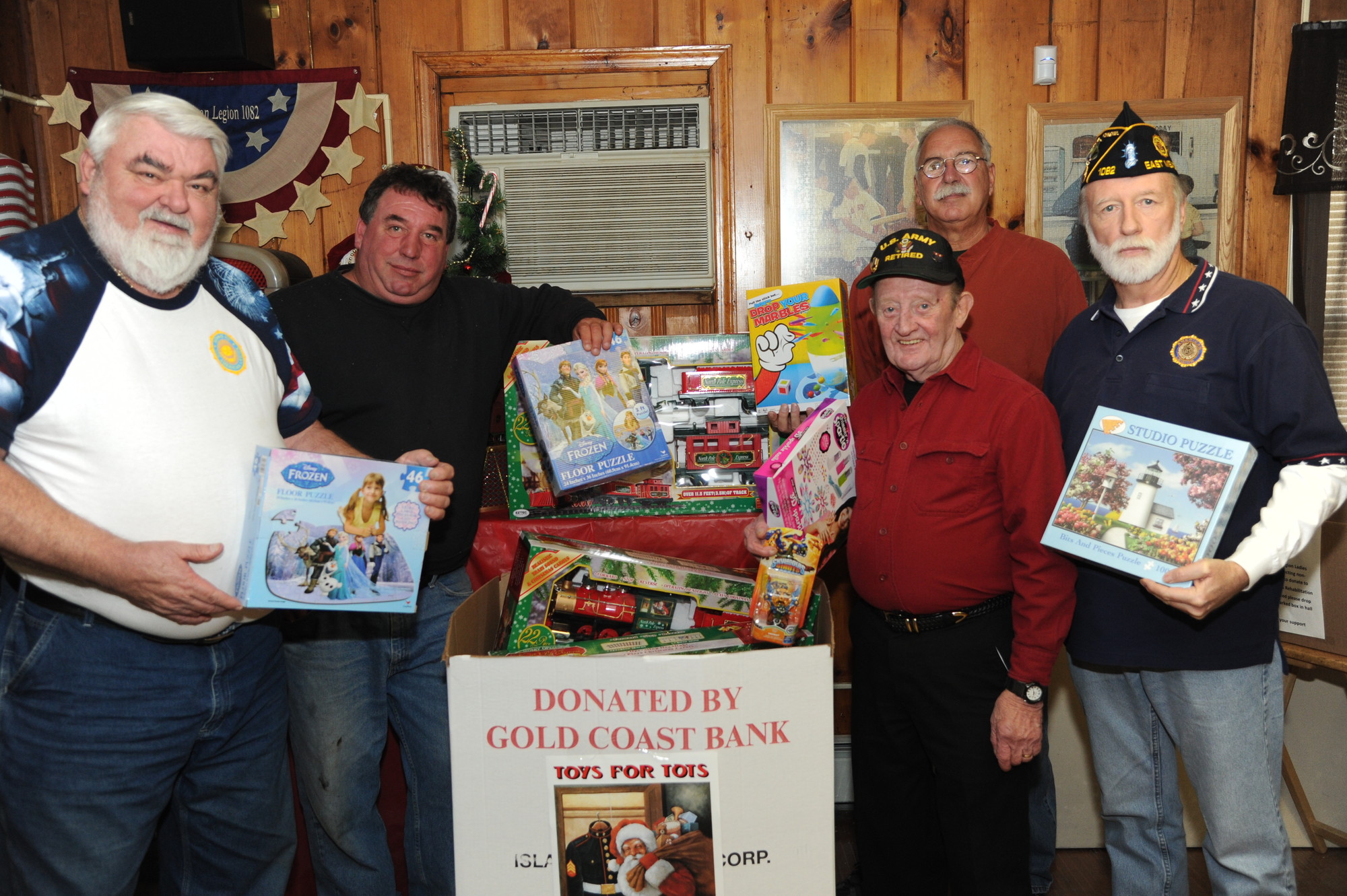 Thanks to $8,000 in donations, Legion members John Flower, far left, Cookie Phillips, Dan Carbonare, Eddie Grant and Fitzsimmons were able to purchase games for a Toys for Tots drive.