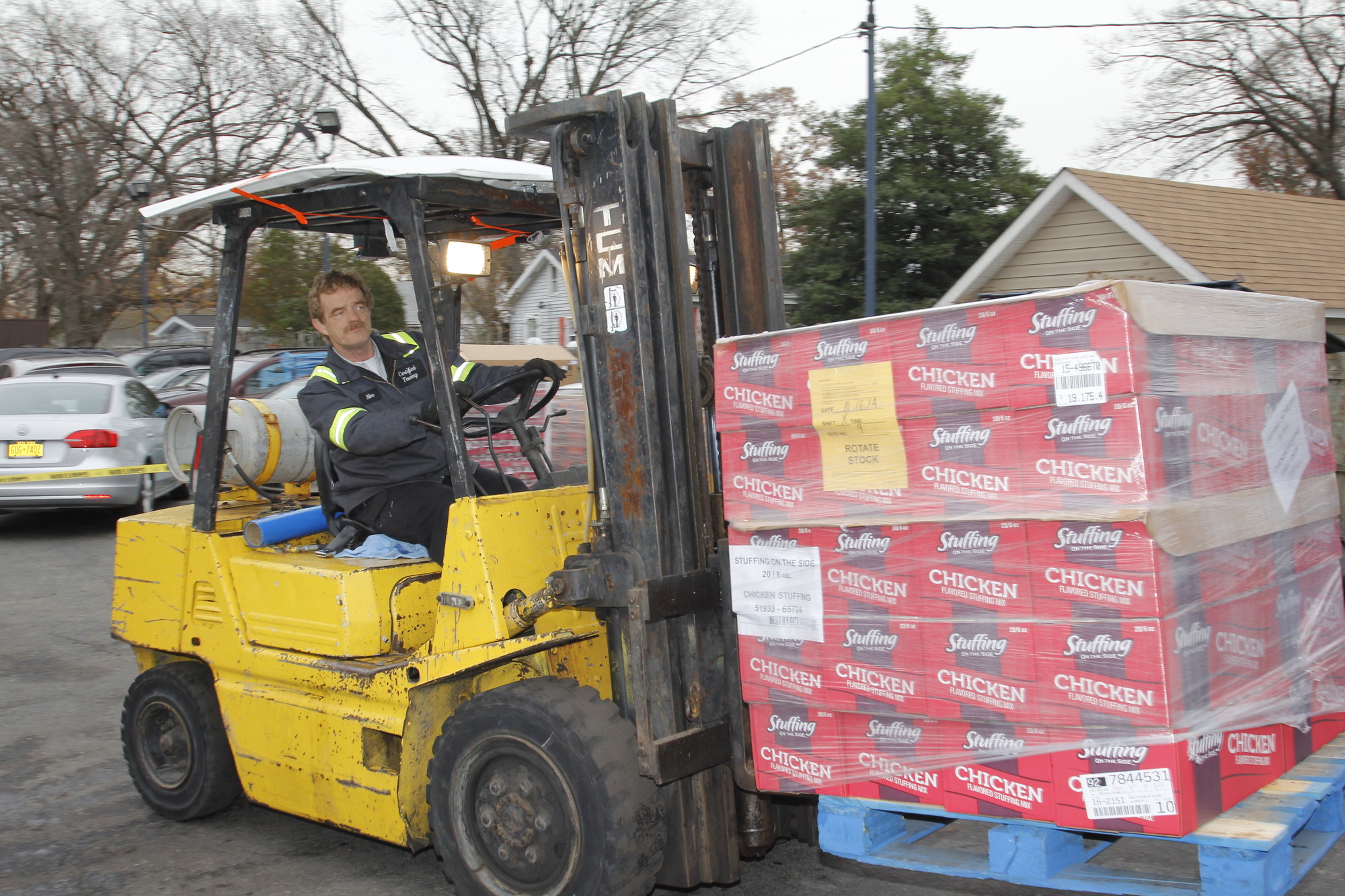 Alex Brown, right, manned the forklift and unloaded pallets of food from the trucks.