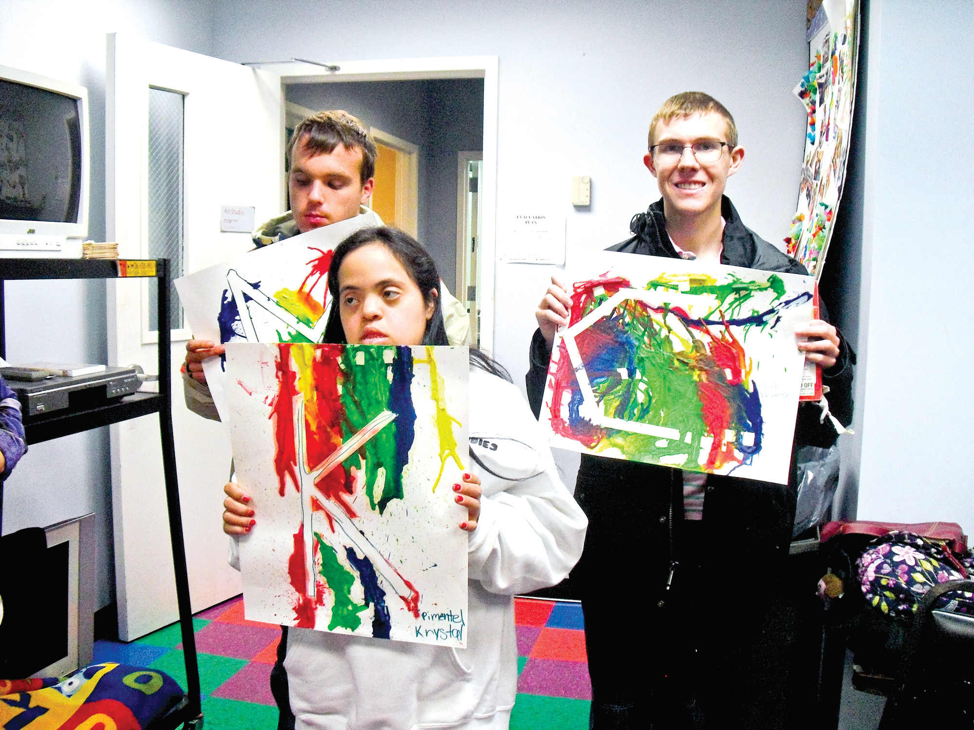 Max McCarthy, Krystal Pimentel and Charlie Butler pose with their finished artwork.