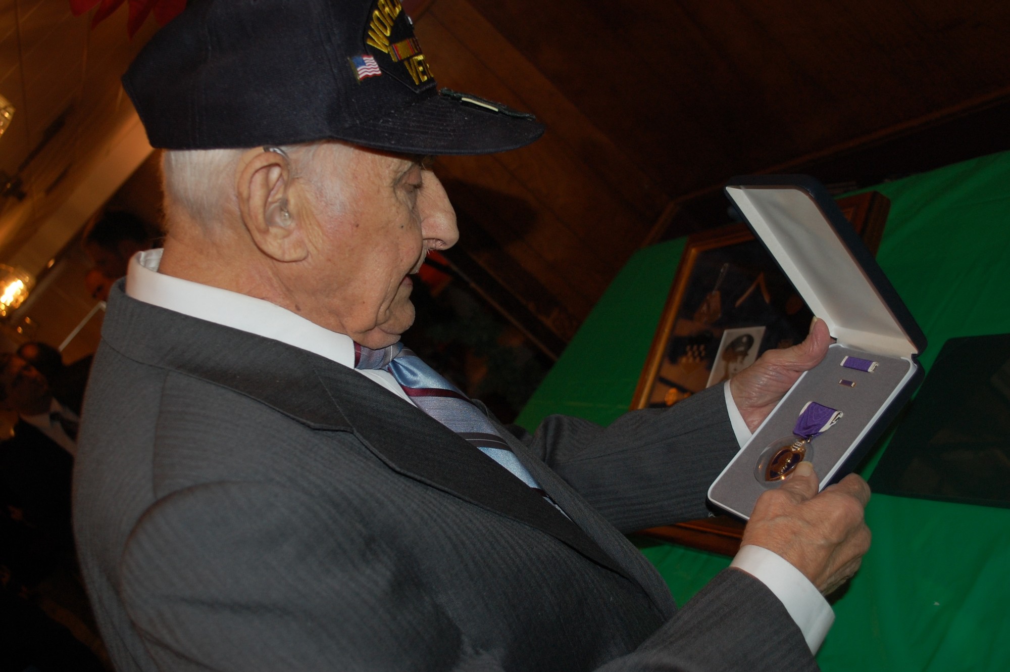 Leonard Stern admired the Purple Heart he was awarded at the Wantagh American Legion Hall on Monday by U.S. Sen. Kirsten Gillibrand.